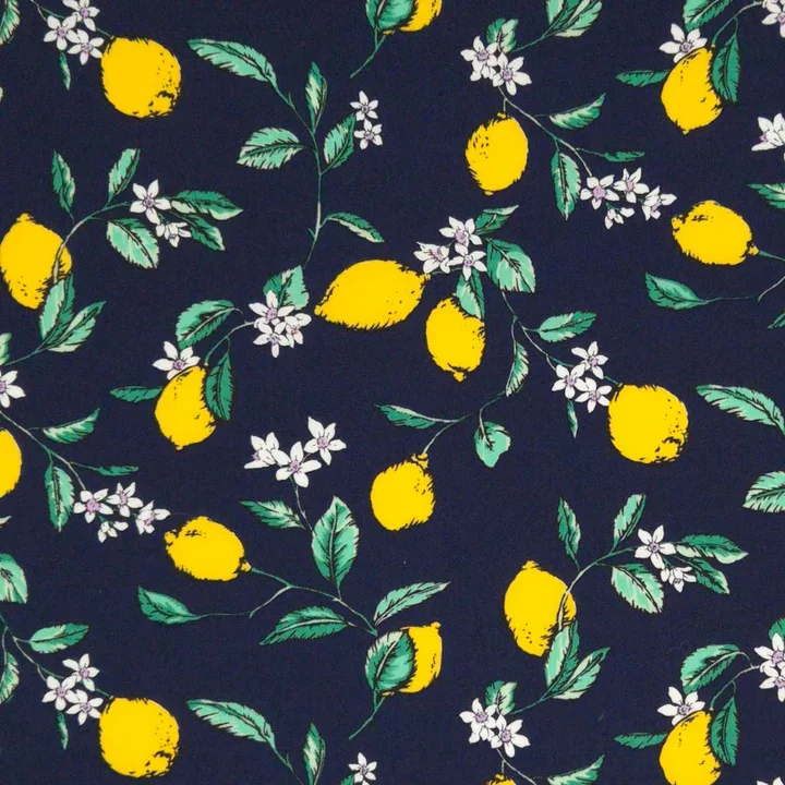 Pattern of yellow lemons, green leaves, and white flowers on a dark background.