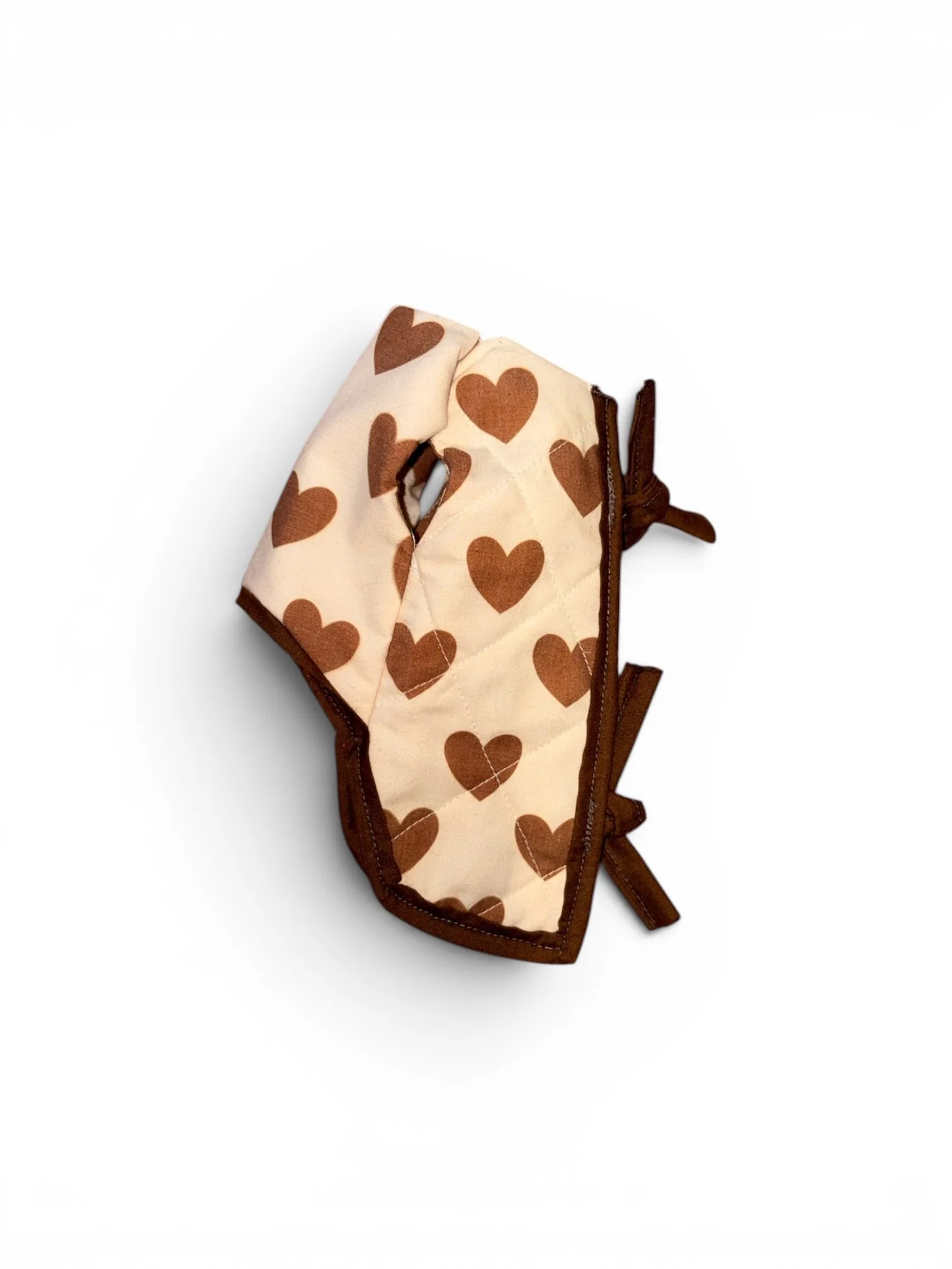 A fabric pouch with a beige background and brown hearts, partially unzipped.