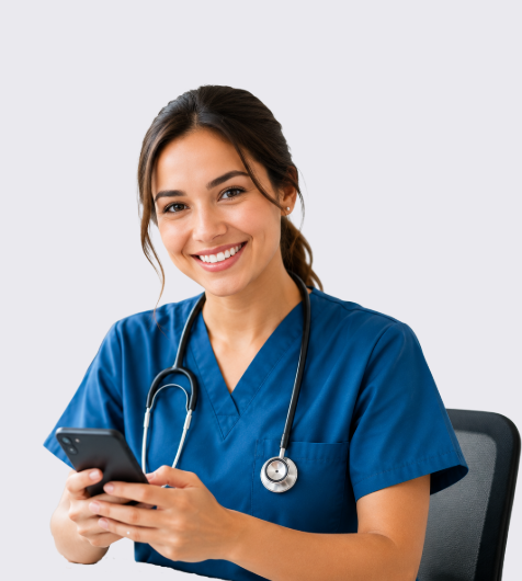 A female healthcare professional wearing blue scrubs and a stethoscope, smiling while looking at her phone against a light gray background.