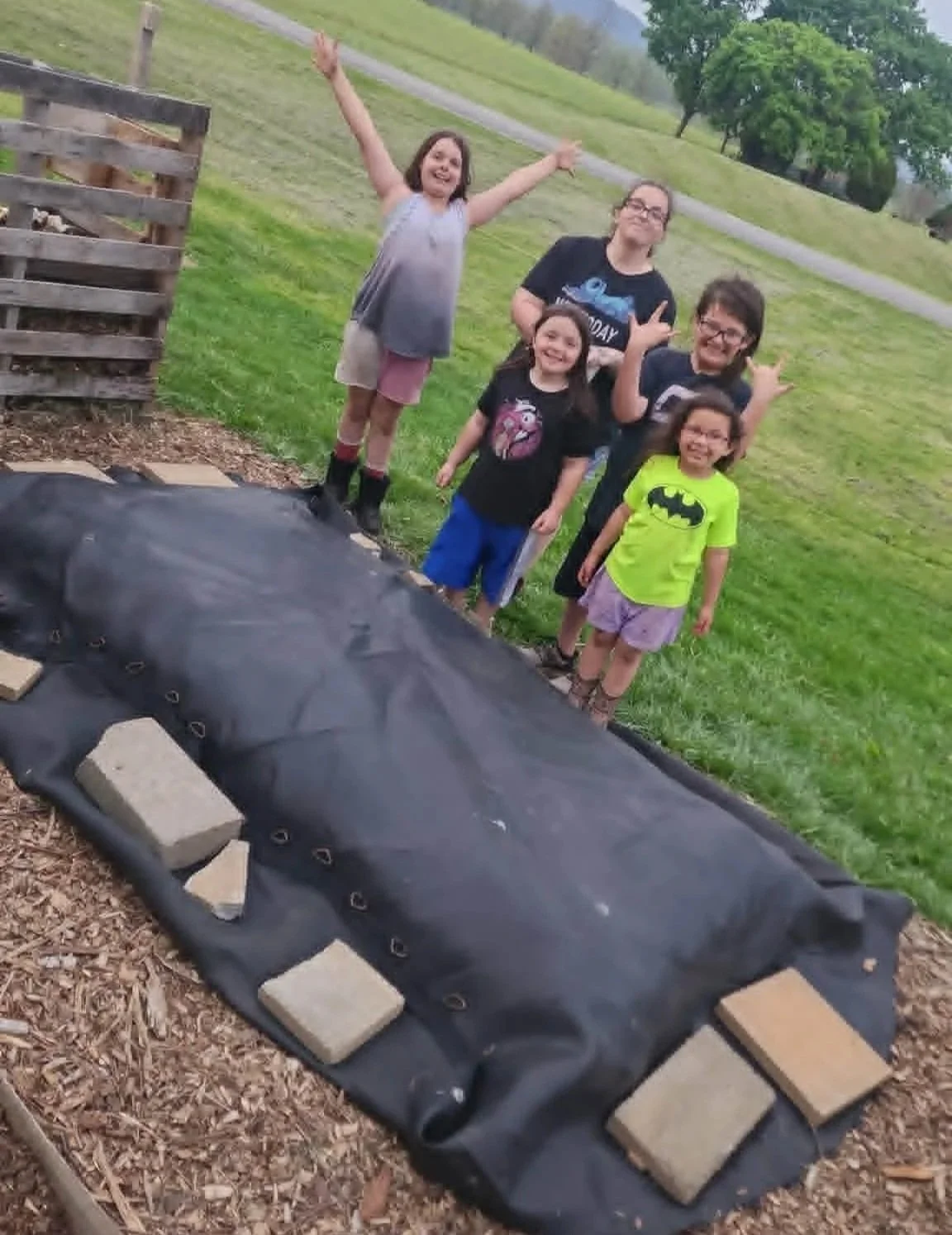 Heathen Farms family working together on a garden project