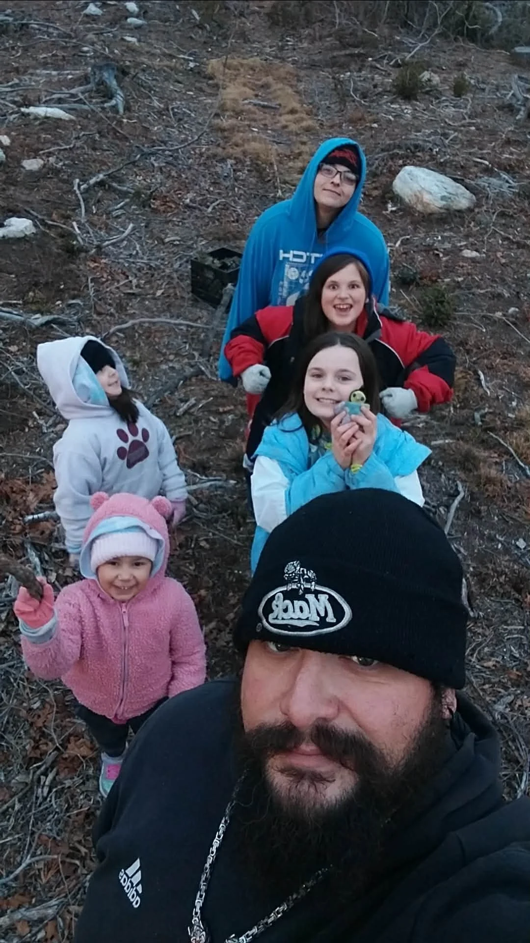 Heathen Farms family gathering natural materials in the forest for their family Yule log