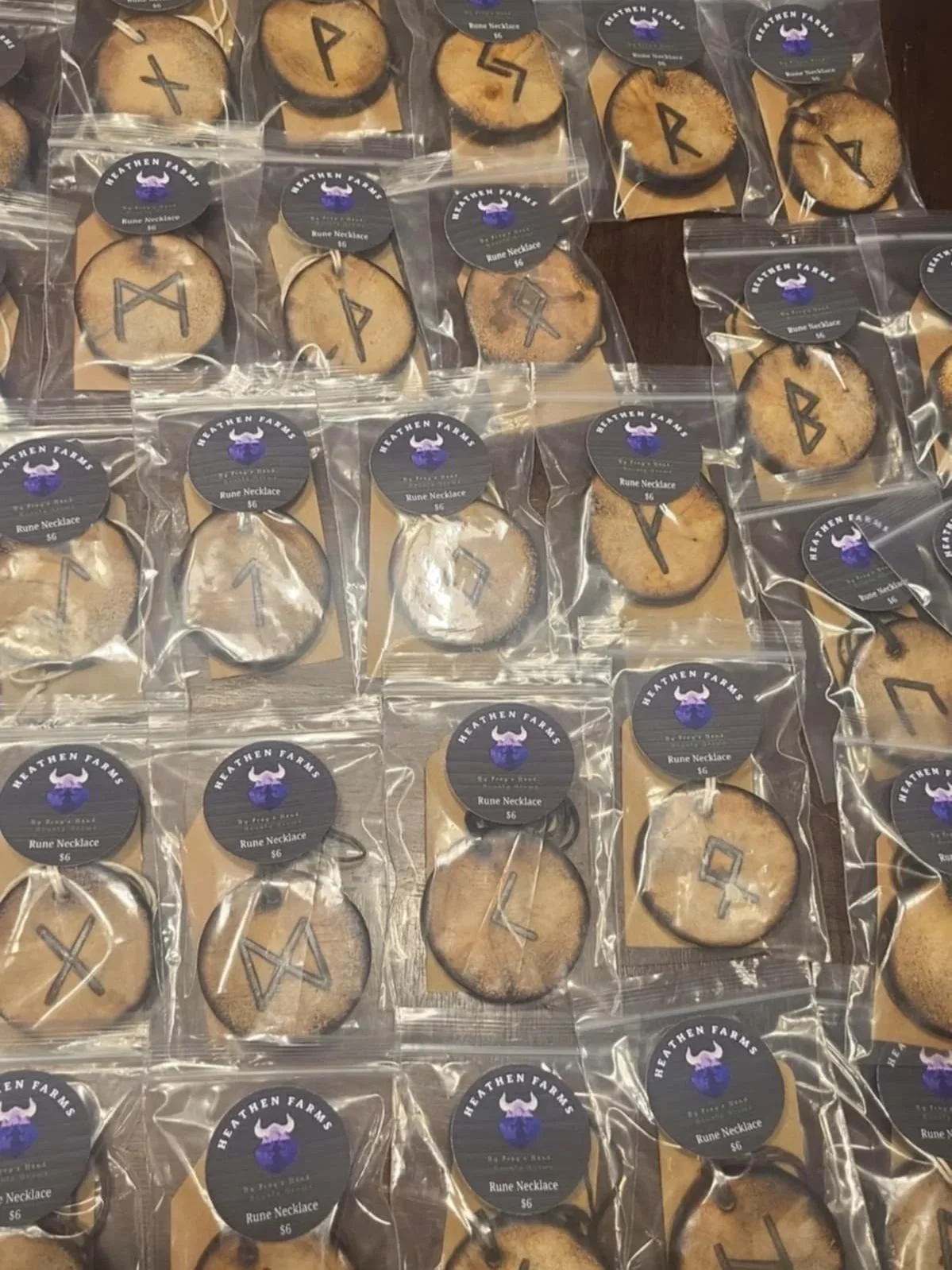 Assorted hand-burned Elder Futhark rune hangers packaged by Heathen Farms