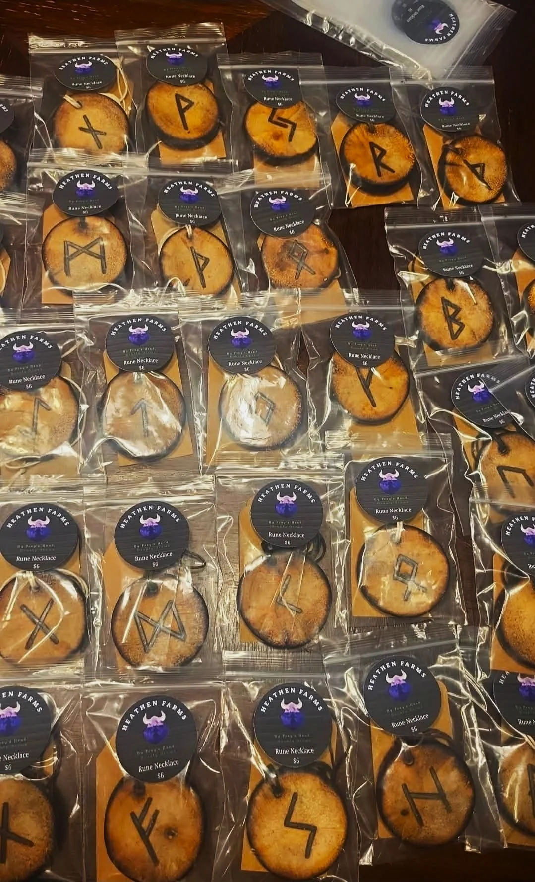 Hand-burned Elder Futhark rune hangers packaged by Heathen Farms