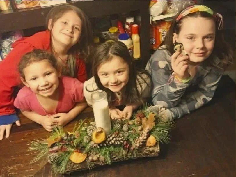 Heathen Farms children with a handmade family Yule log centerpiece