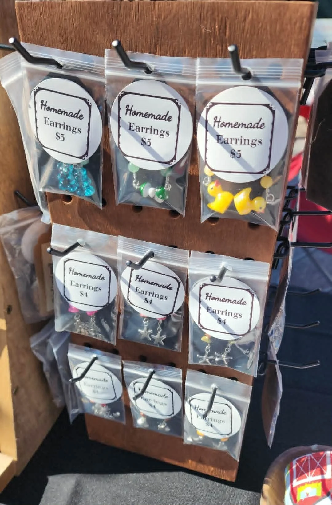 Small-batch handmade earrings displayed at the Heathen Farms market table