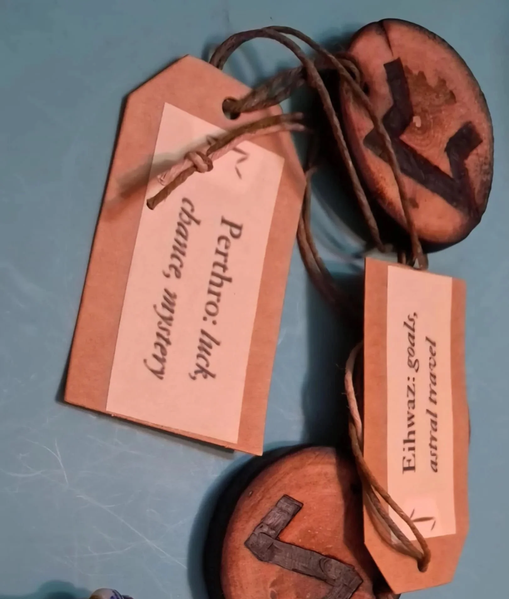 Natural wood Elder Futhark rune hangers with hand-burned symbols and hanging cords