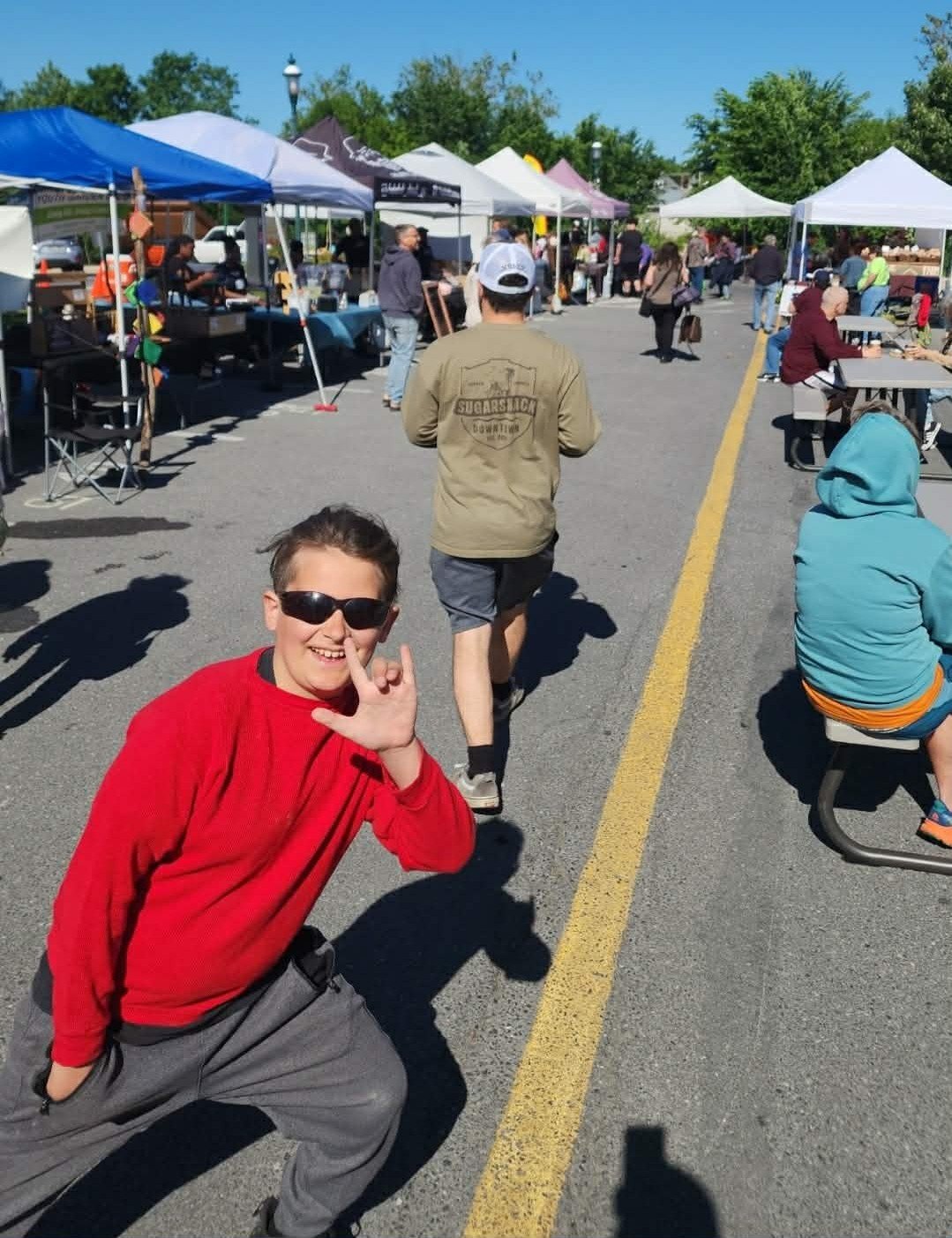 Heathen Farms family member at a busy outdoor North Square farmers market in Chambersburg, Pennsylvania
