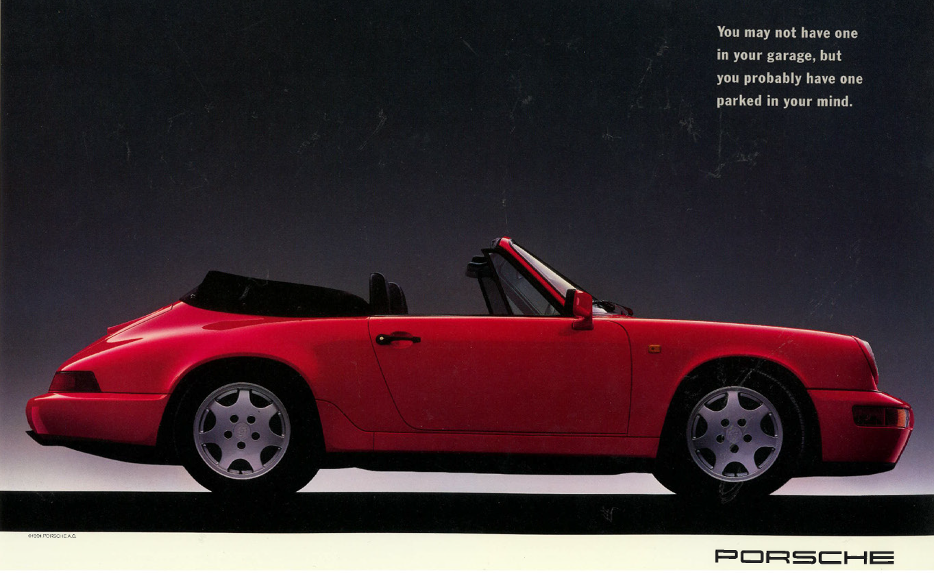 Red Porsche convertible sports car against a dark background with a quote about mental parking, Porsche logo at bottom right.