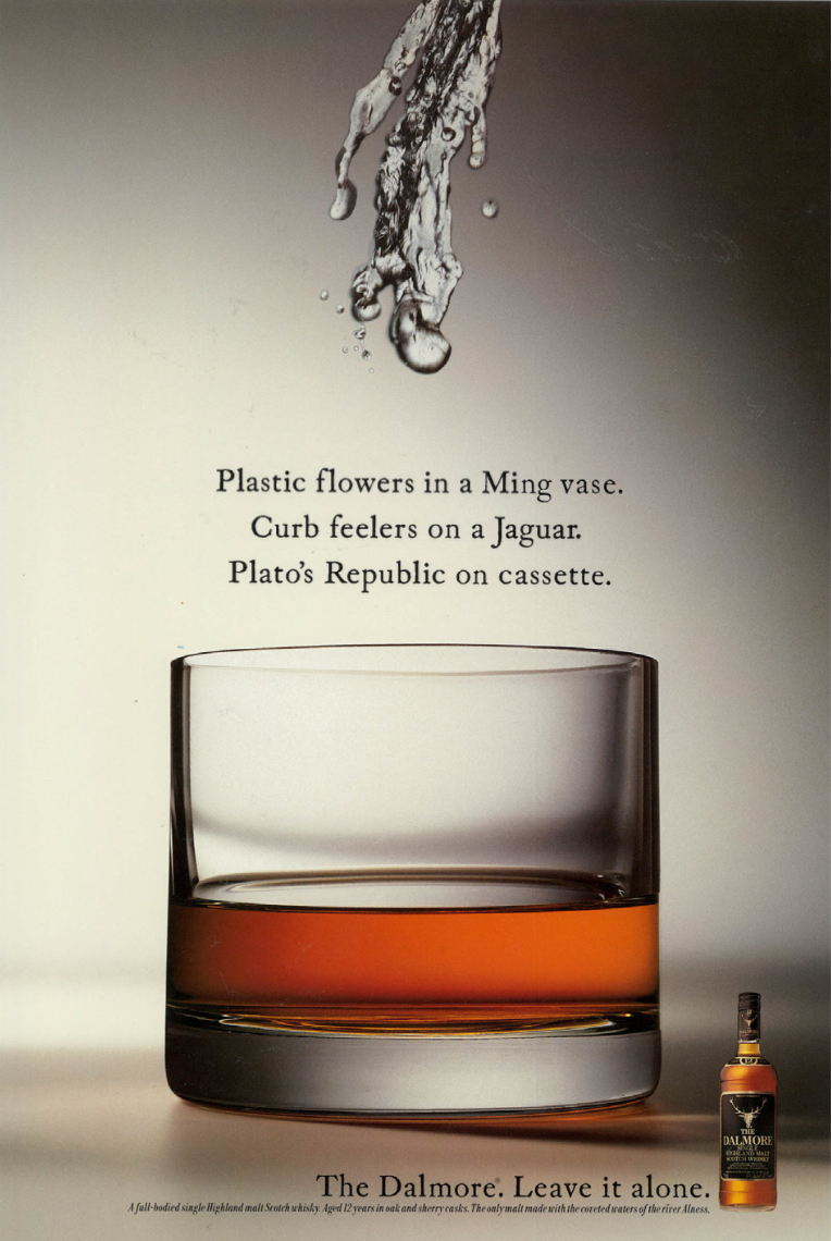 An advertisement featuring a glass of whiskey with text describing various cultural references and a small bottle of whiskey in the lower right corner.