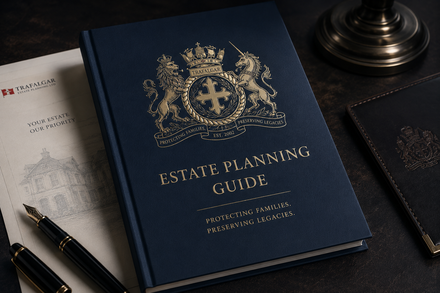 A blue binder titled 'Estate Planning Guide' with gold emblem on cover, surrounded by a pen, estate planning documents, and other similar binders on a dark surface.