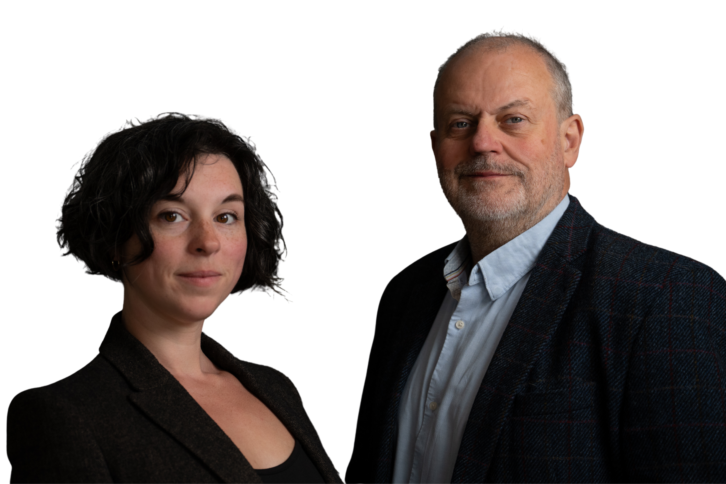 A woman with dark curly hair and a man with a gray beard and short hair posing together in formal attire.