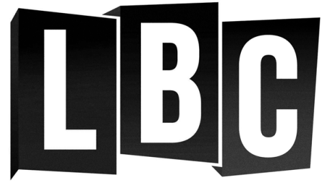 Silhouette of a person in a yoga pose with crossed legs, hands in prayer position, and a mountain and sun in the background.