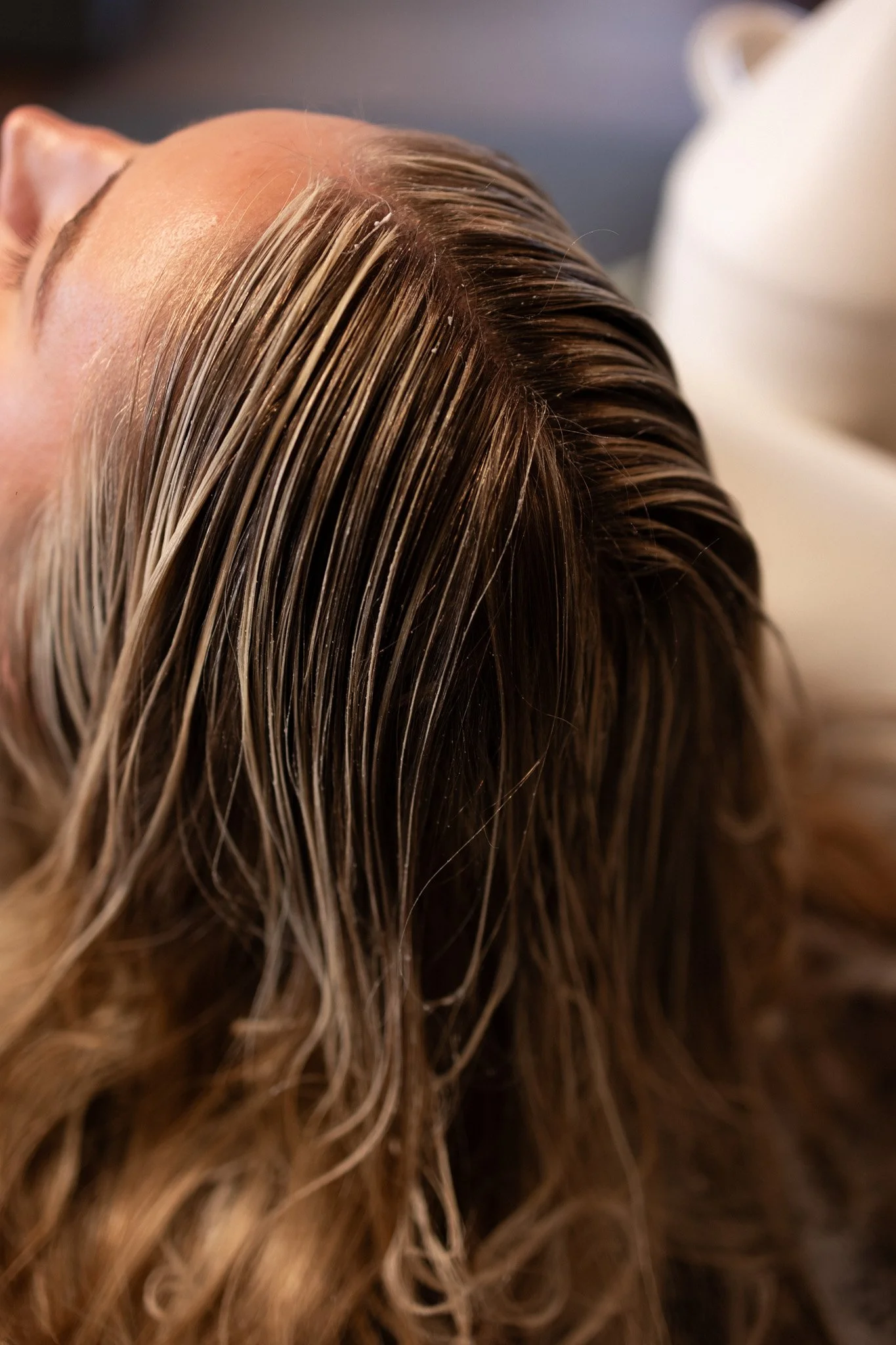 Nahaufnahme von blondem, gewellten Haar, das nach einem Friseurbesuch glänzt.