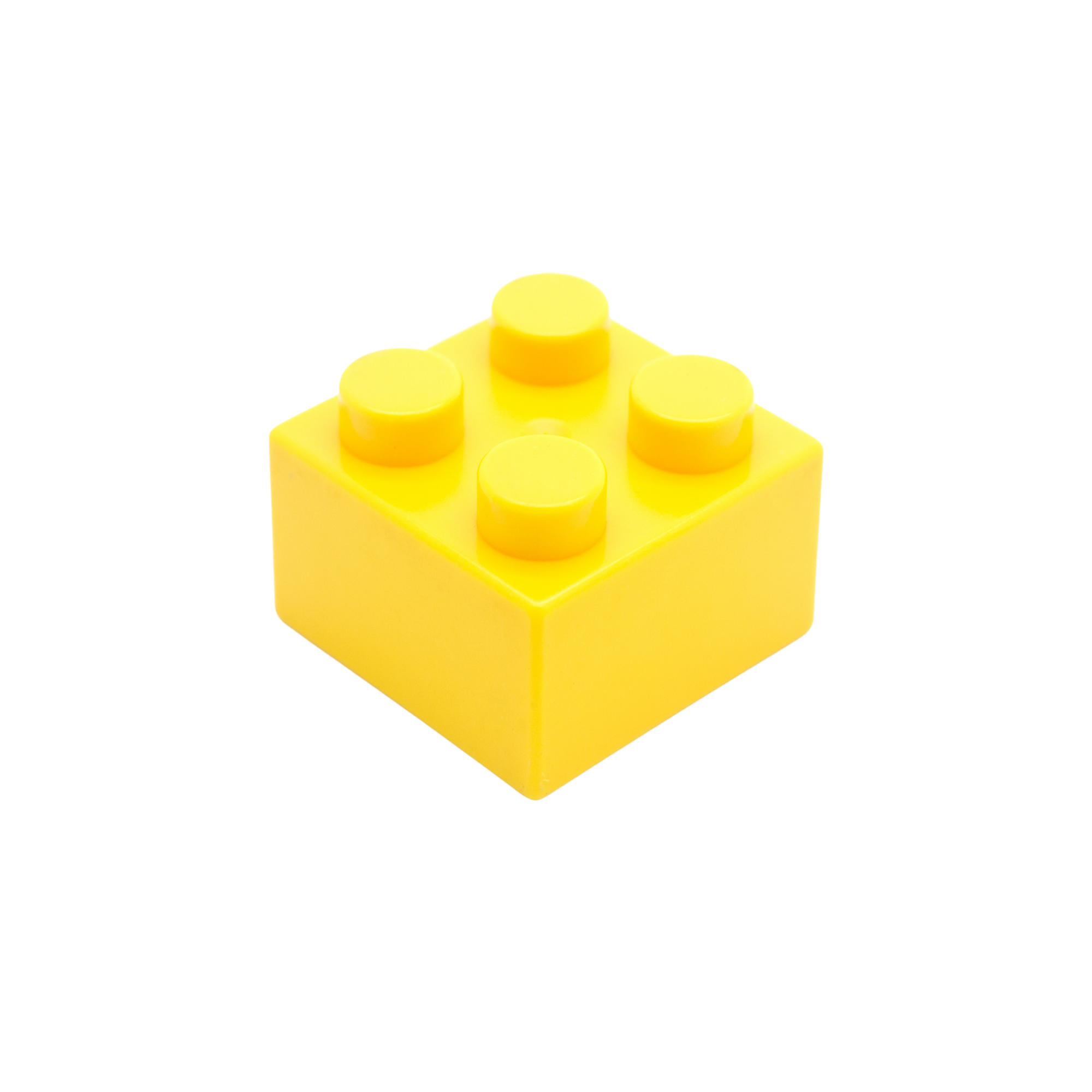 Close-up of a yellow lego brick with six studs, isolated on a white and pale yellow background.