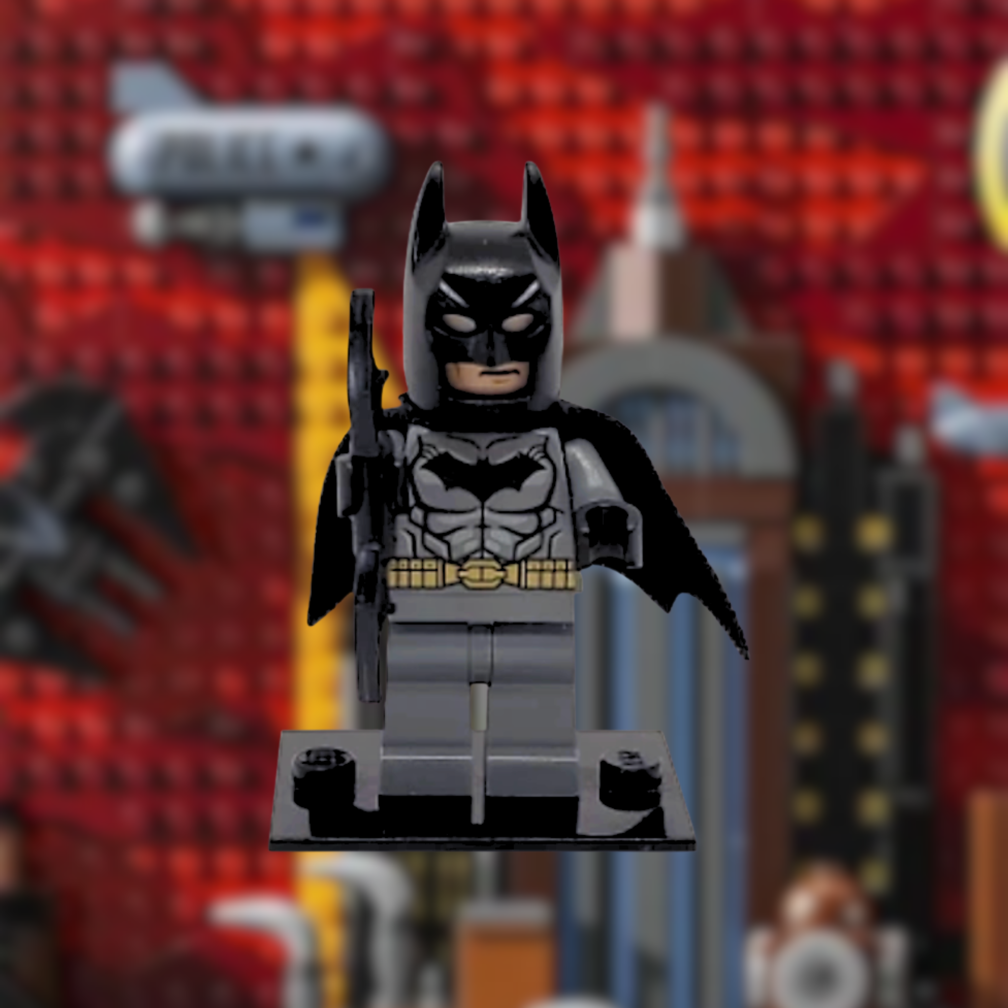 LEGO Batman figurine with raised finger, in front of a blurred background of LEGO store shelves with LEGO sets and figures.