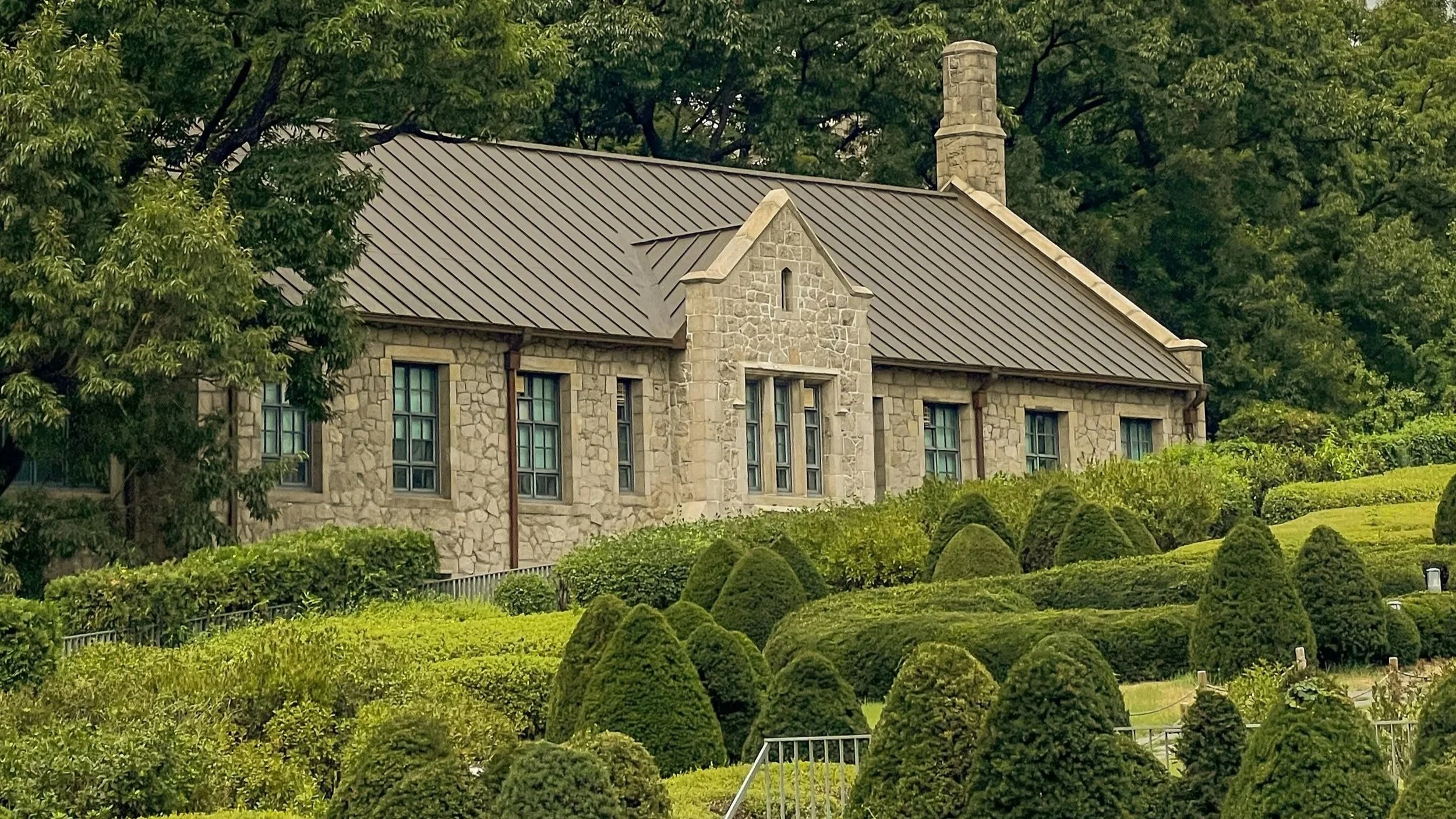 are & are Landscape Design Studio - Garden design with topiary pieces -  lush greenery and neatly trimmed shrubs.