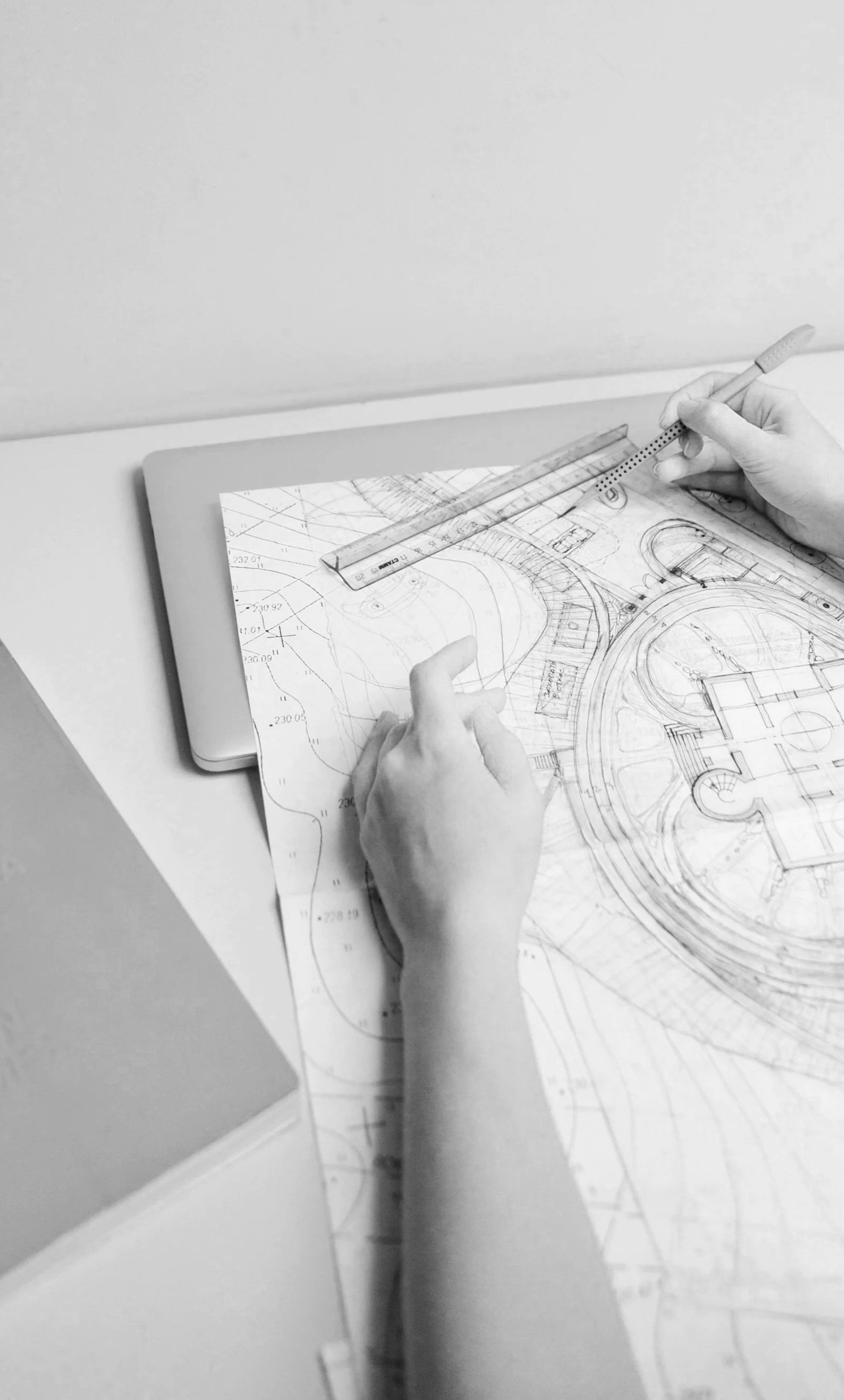 Landscape design plan being drawn with a ruler and pencil during the garden design process.