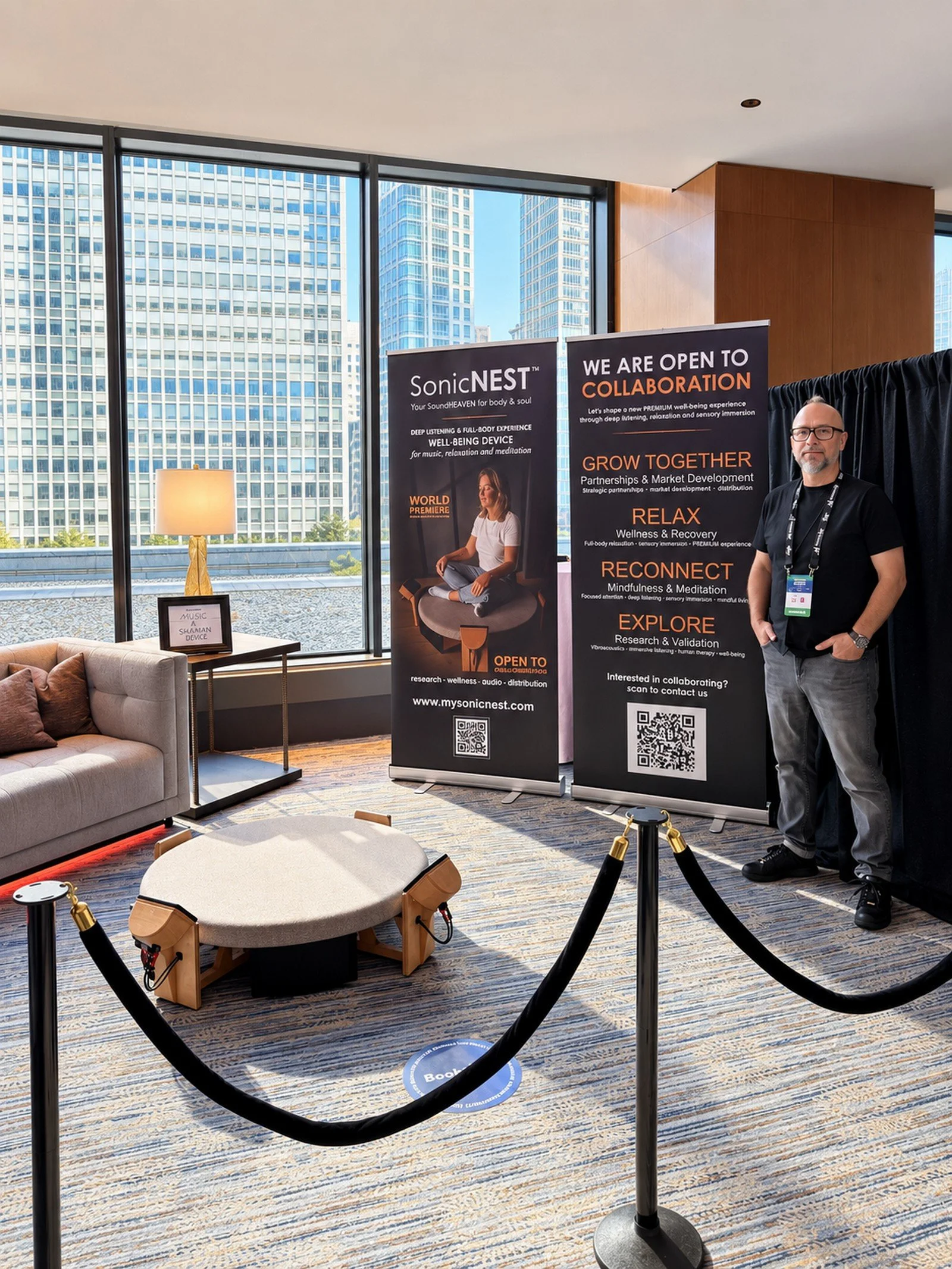 SonicNEST™ presentation area at Biohackers World Chicago 2026, showing the immersive listening platform in a premium wellness and hospitality-style lounge.