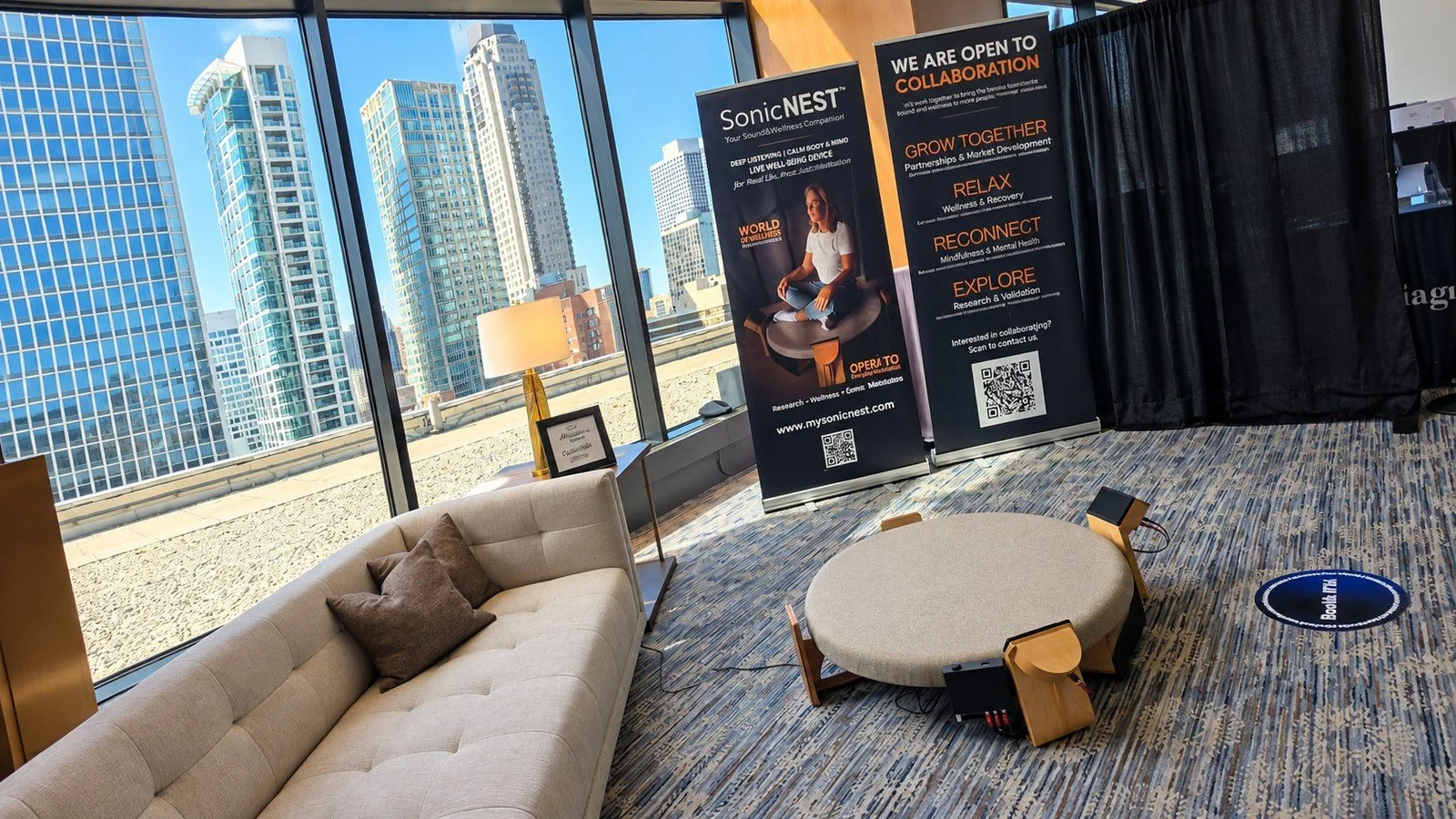 SonicNEST™ VIP Lounge setup at Biohackers World Chicago 2026, showing premium interior design, cooperation banners and immersive well-being technology presentation.