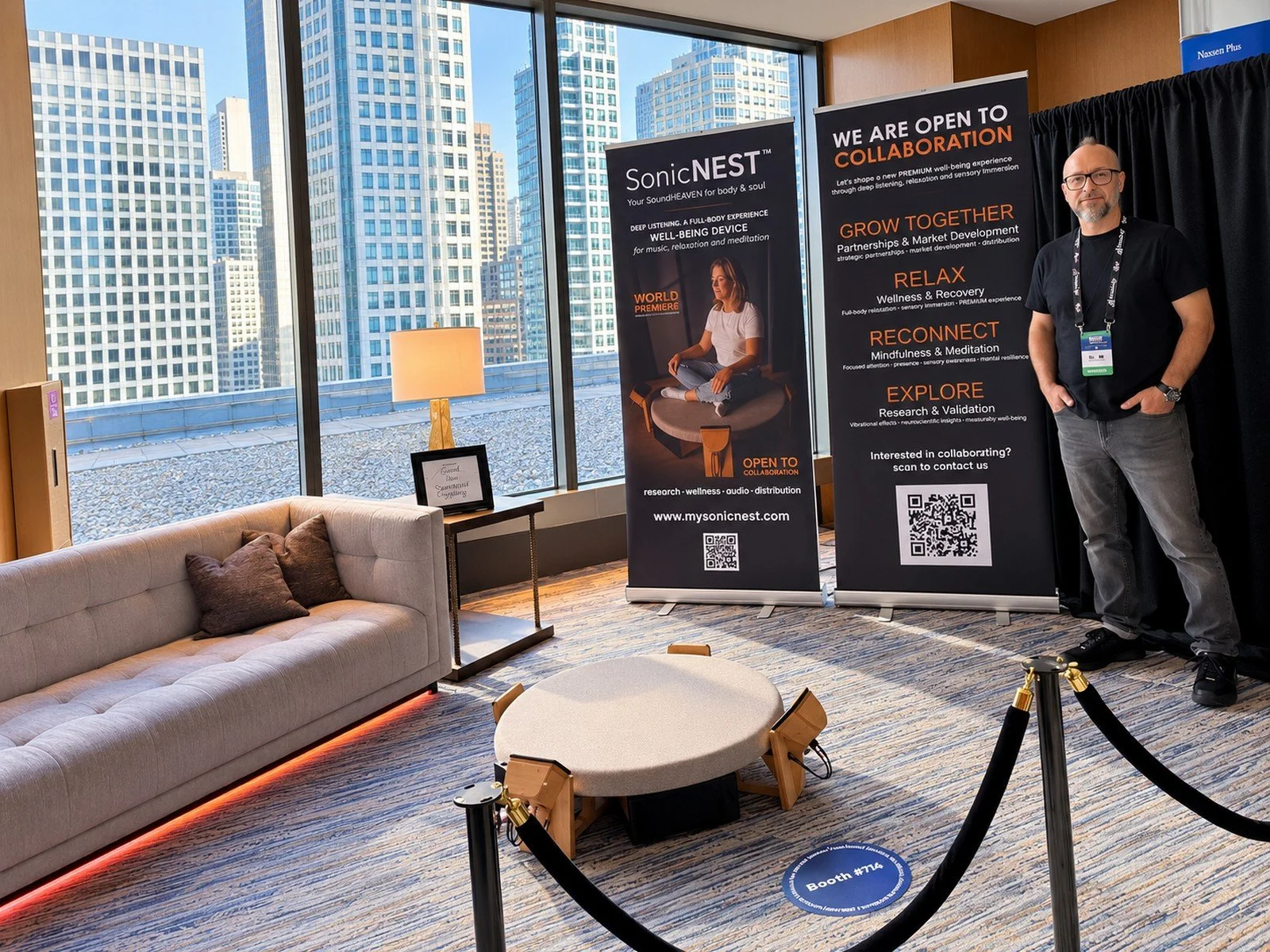 Founder and designer Tom Fechter presenting SonicNEST™ at Biohackers World Chicago 2026 inside the VIP Lounge with banners for cooperation, research and wellness applications.