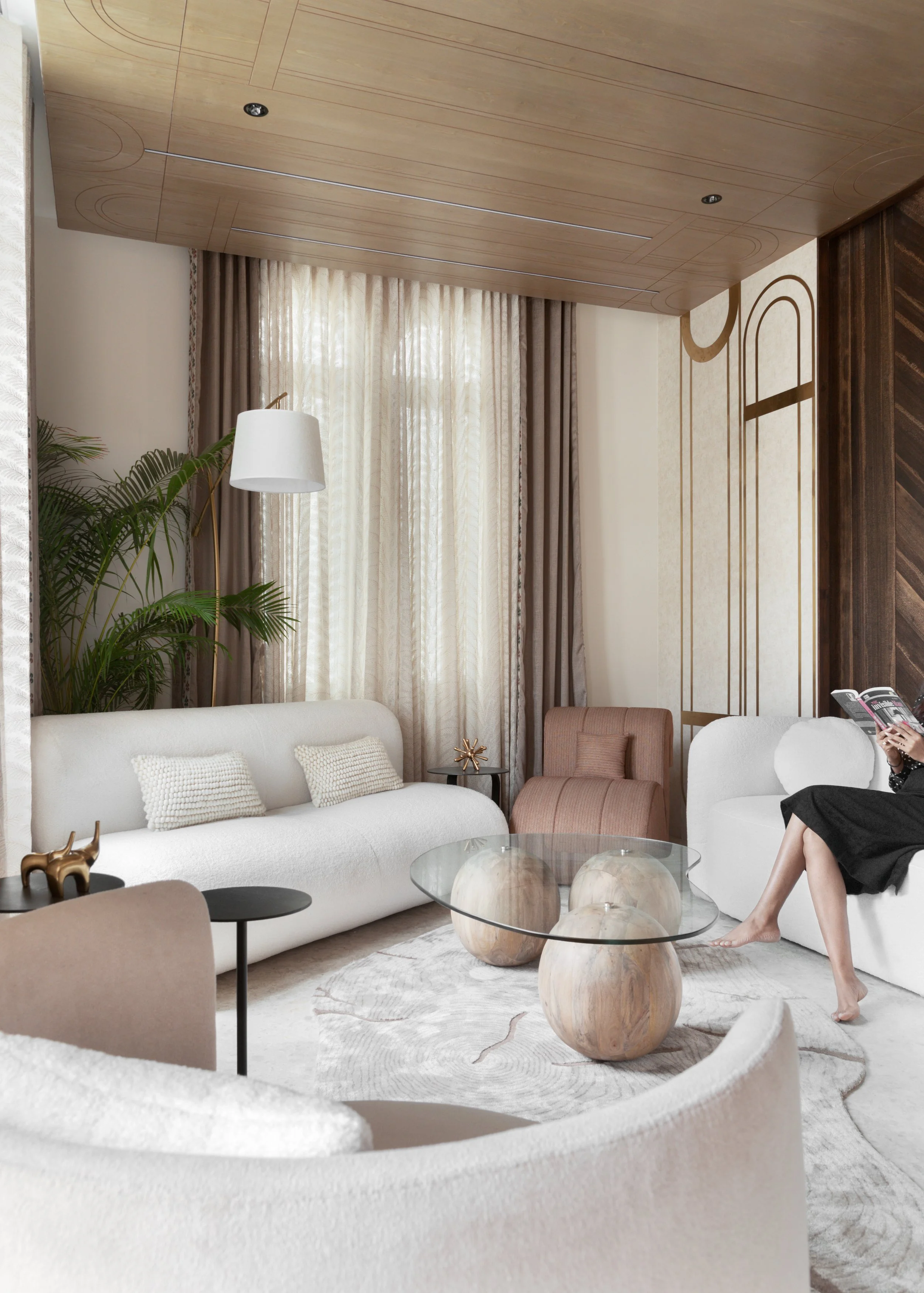 Modern trends have been brought together in the conventional requirements of a bungalow. The informal living room has white furniture pieces balanced with ash-wood panelling at the back and smoked grey veneer in the ceiling with a touch of brass.