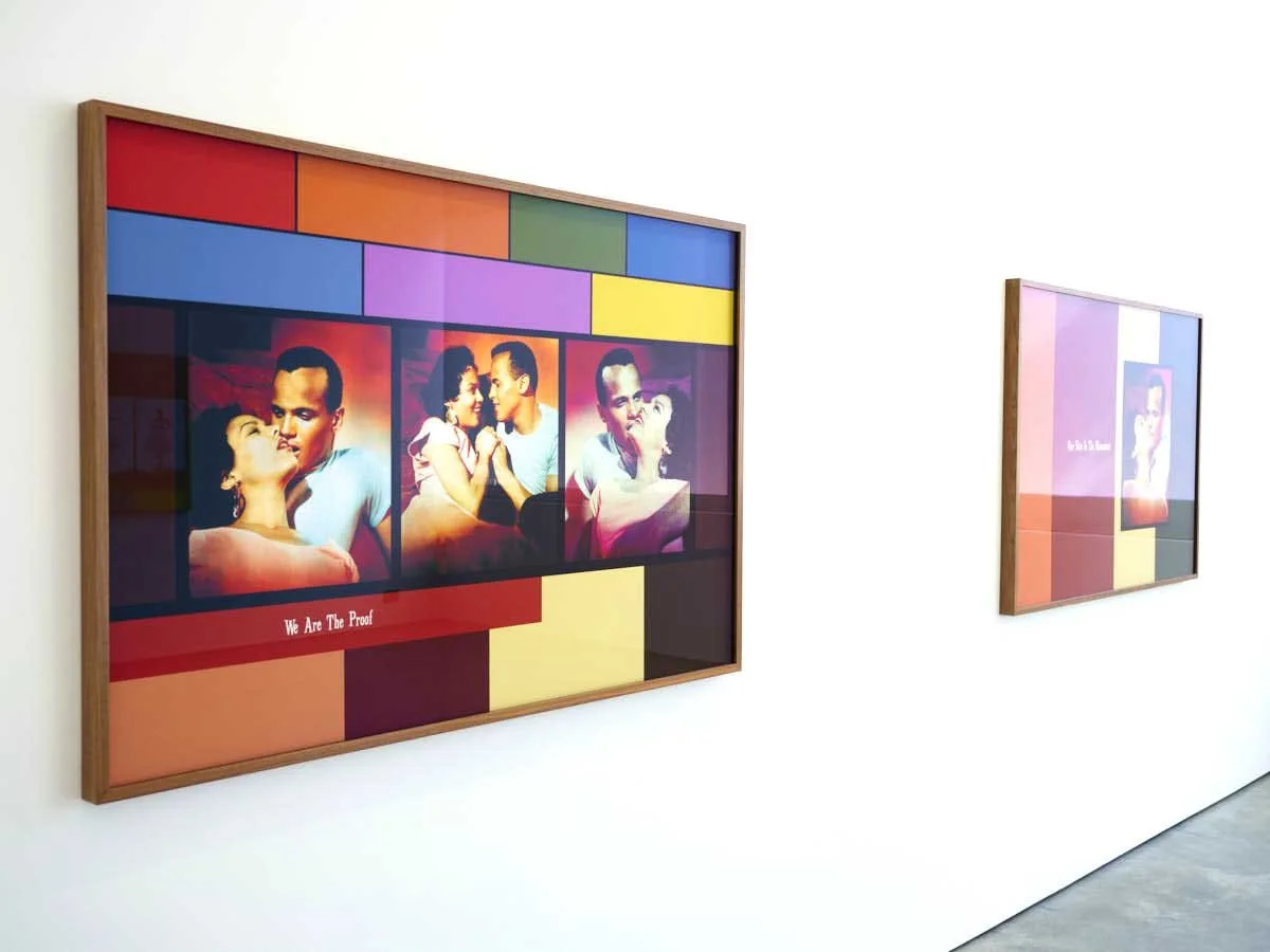 Two framed art pieces on a white gallery wall, each featuring scenes from the movie 'We Are The Proof' with colorful backgrounds and characters in romantic poses. John Akomfrah, Lisson Gallery, London
