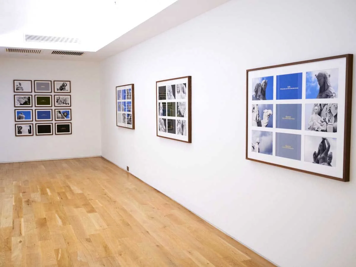 Art gallery with framed photographs and artwork on white walls, wooden floor, and ceiling lighting Artist John Akomfrah, Lisson Gallery, London