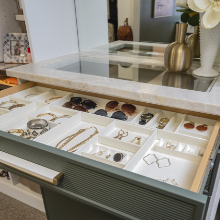 Jewelry display case with various earrings, necklaces, and rings in a jewelry store display