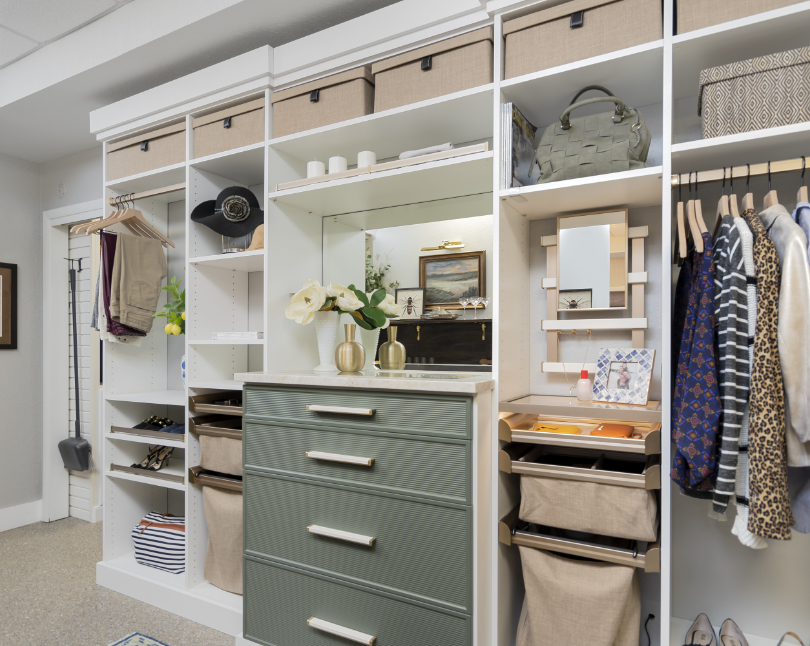 Closet with organized shelves and drawers, displaying hats, bags, clothes, and decorative items.