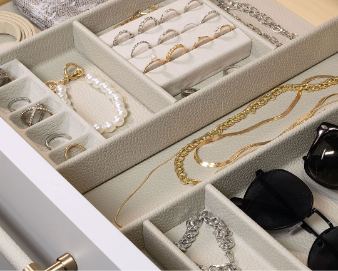 Jewelry collection including rings, necklaces, bracelets, earrings, and watches organized in a jewelry drawer