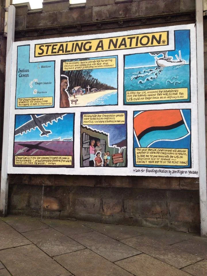 A colorful infographic titled 'Stealing a Nation' with illustrations and text about the history of Diego Garcia, including the displacement of local inhabitants and the military use of the island by the U.S. and UK, featuring a map, an airplane, a bo