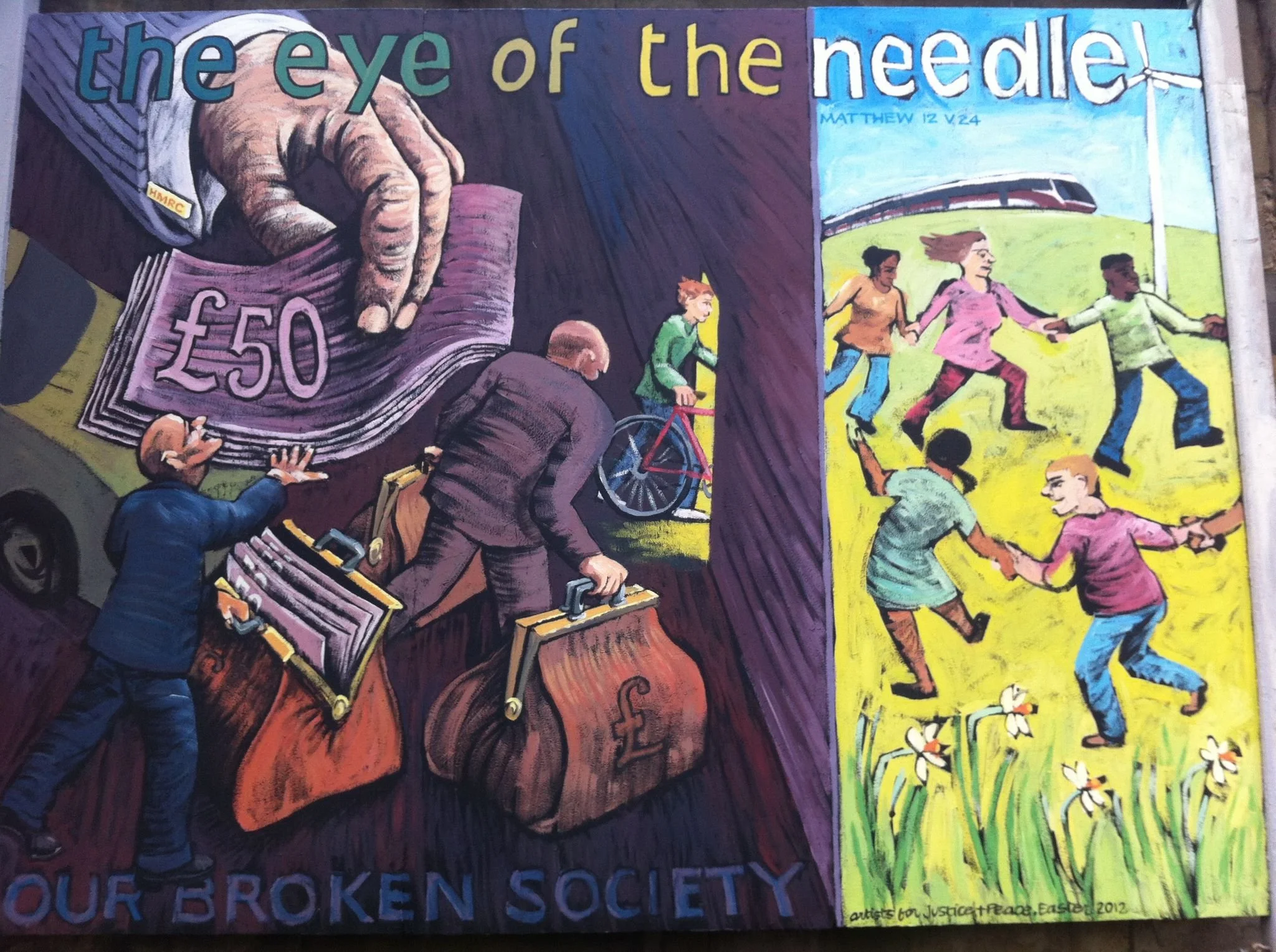 A colorful mural with the phrase 'the eye of the needle' at the top. The mural depicts a large hand threading a needle with money, and children playing and biking around a park with a train in the background. The artwork is vibrant and illustrative, 