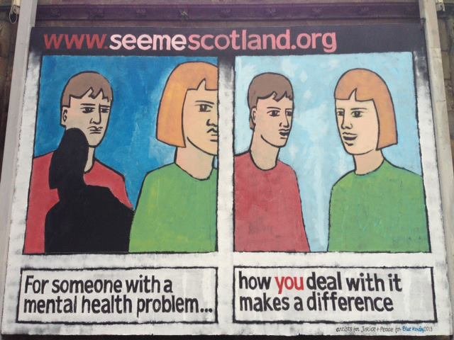 Street poster with cartoon drawings of two men and one woman, showing a progression from a somber to a happier mood. The poster promotes mental health support in Scotland, with the website www.seemescotland.org and the tagline 'For someone with a men