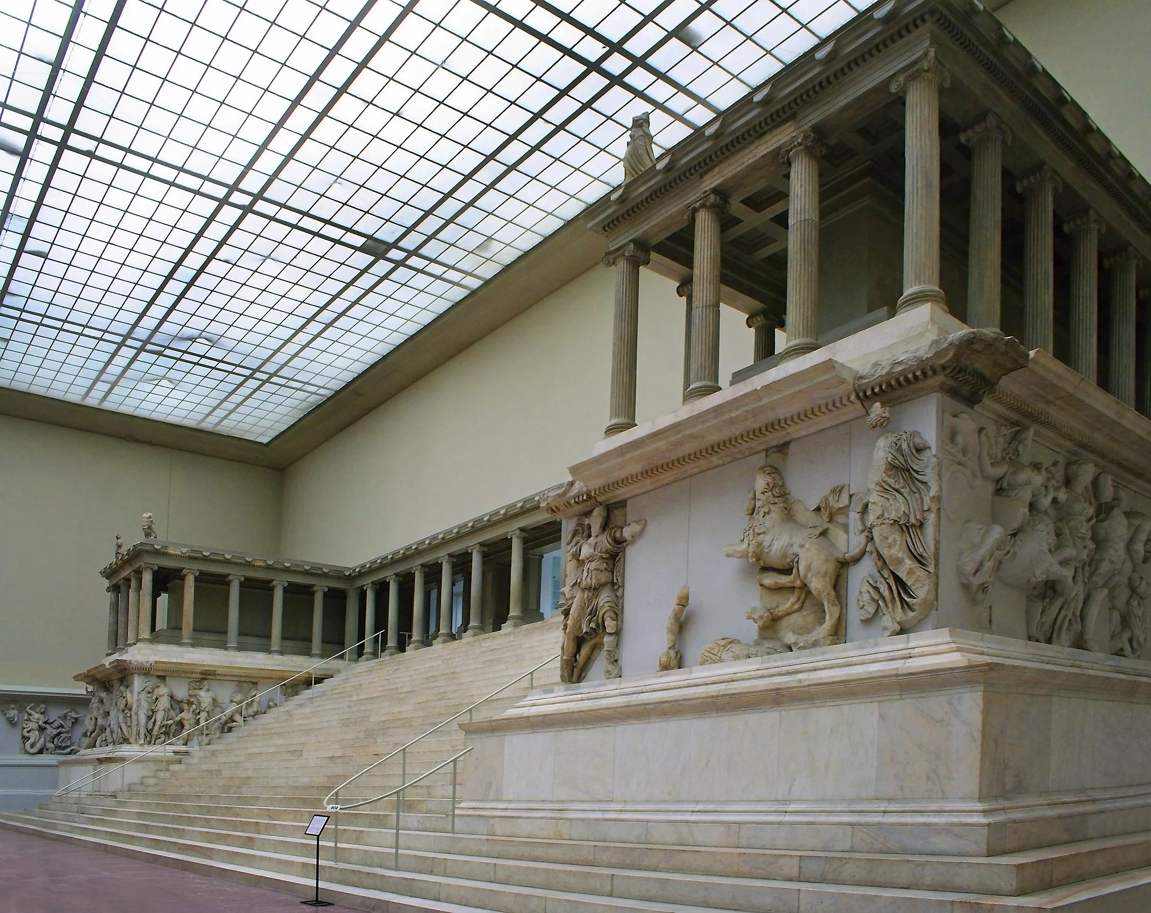 Ancient Greek-style building with columns and ornate sculptures, inside the museum.