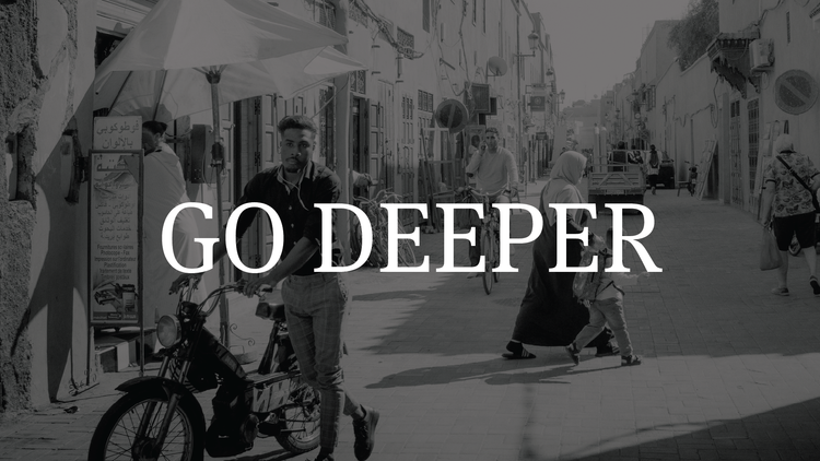 A black and white street scene with people walking and cycling, with the text "GO DEEPER" overlayed in the center.