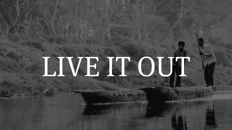 Two people on a makeshift raft on a river with trees in the background, overlaid with the text "LIVE IT OUT".