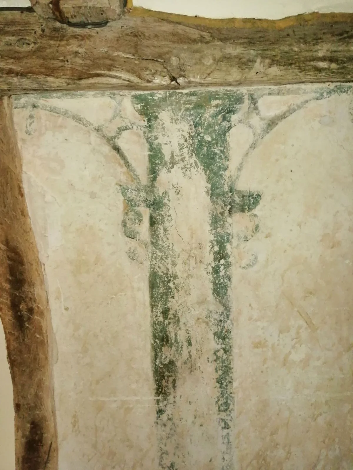 Ancient fresco of a tree with spreading branches, painted on a weathered wall with visible cracks and peeling paint.