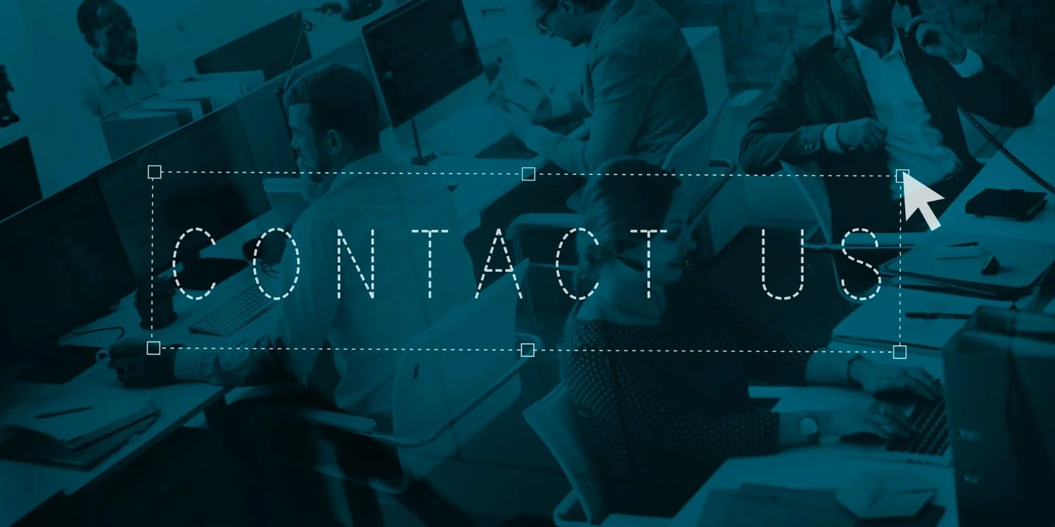 Office scene with multiple people working at desks, some on computers, with a large overlay text saying 'CONTACT US' and a cursor pointing to the top right corner.