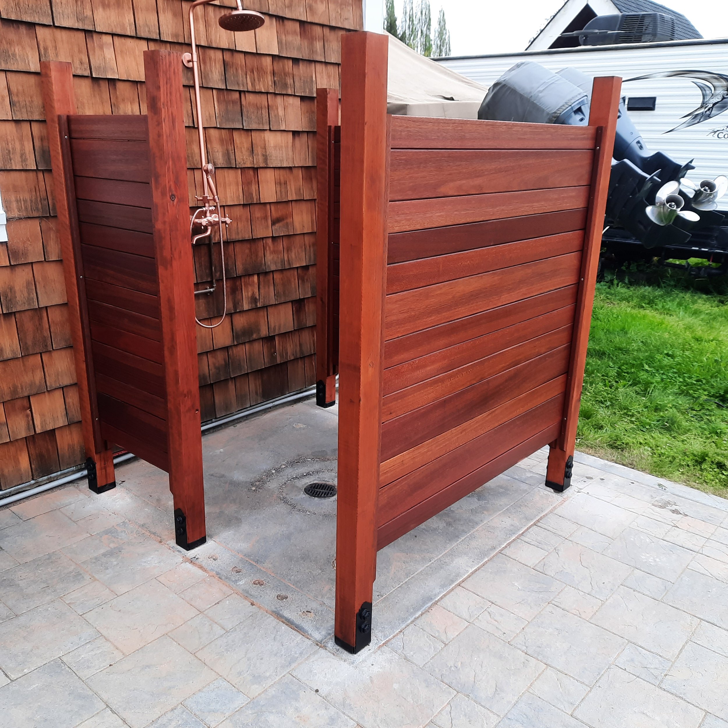Outdoor wood shower enclosure and privacy screen, decorative concrrete, with paved patios.