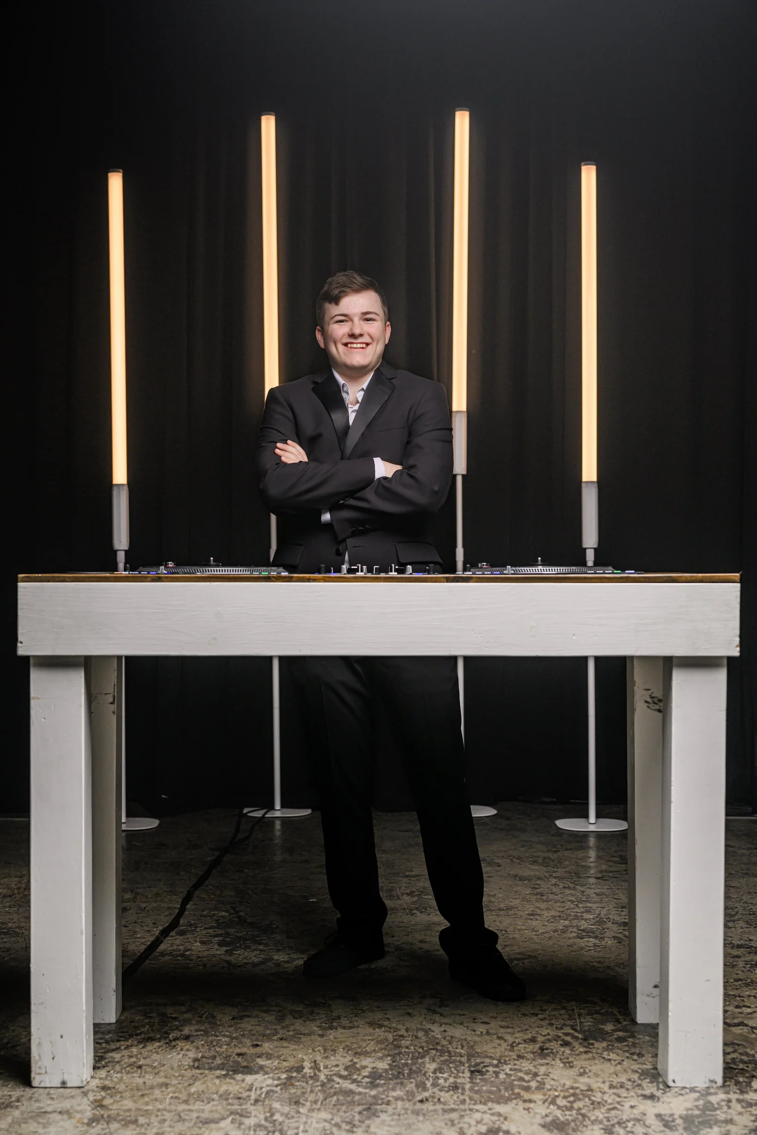 Blake Hauser standing behind his DJ booth