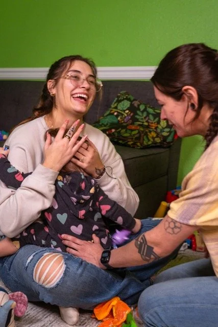 Dr. Lacy adjusting a toddler while mom holds her. -Vancouver, WA