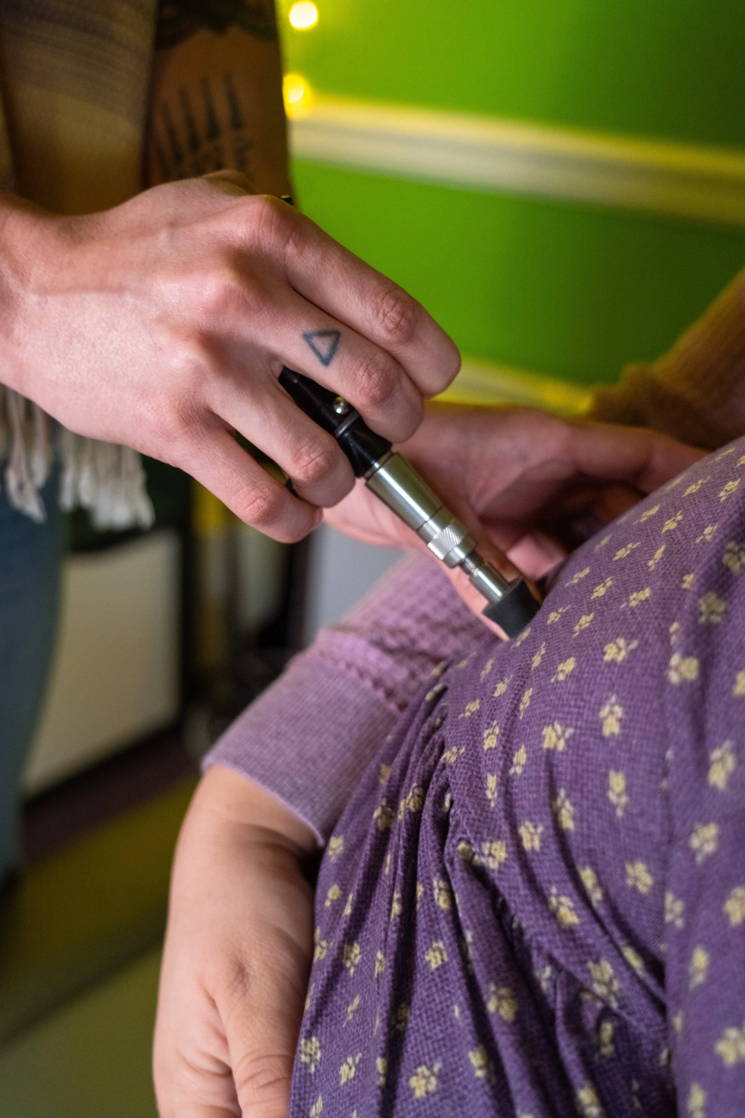 Dr. Lacy adjusting a toddler with activator adjusting tool - Vancouver, WA