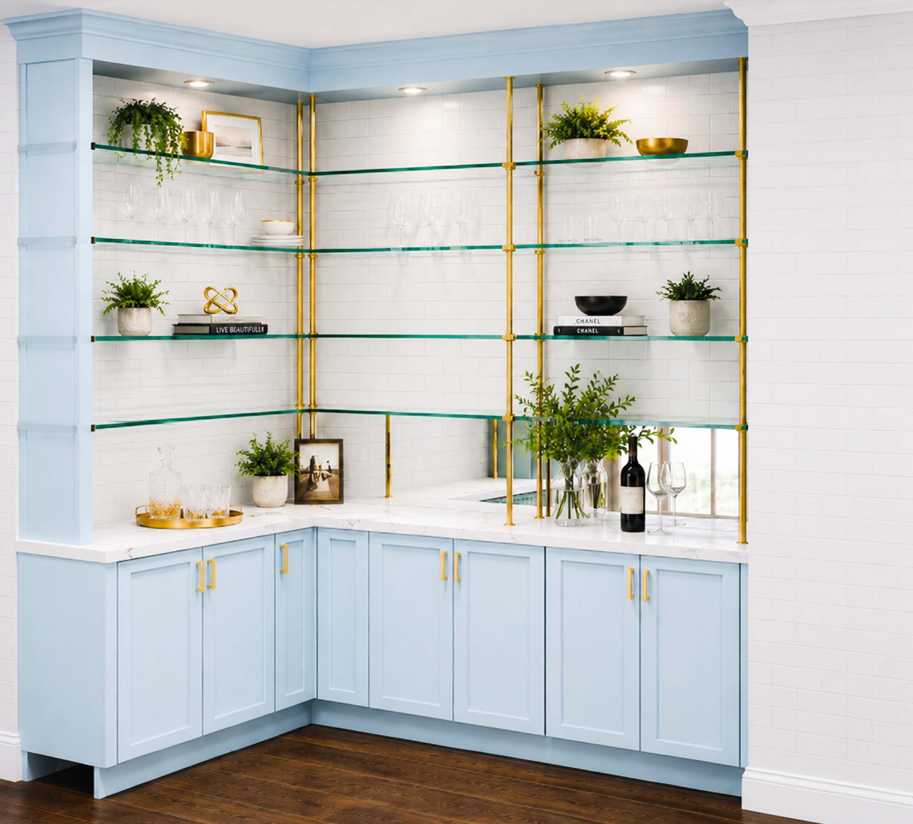 Modern kitchen with light blue cabinets, white marble countertops, and glass shelves supported by gold pipes, decorated with potted plants, books, and glassware.