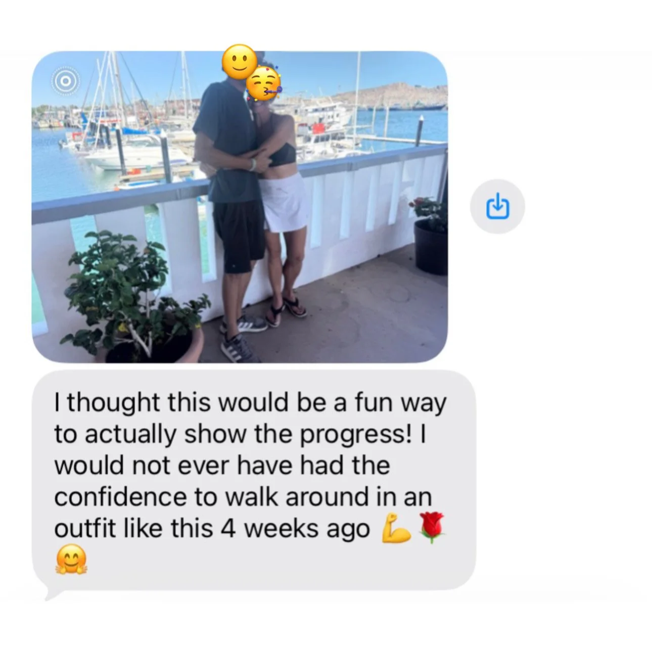 Two people, with emoji faces, standing on a balcony near a marina with sailboats and a mountain background, dressed casually, posing for a photo.