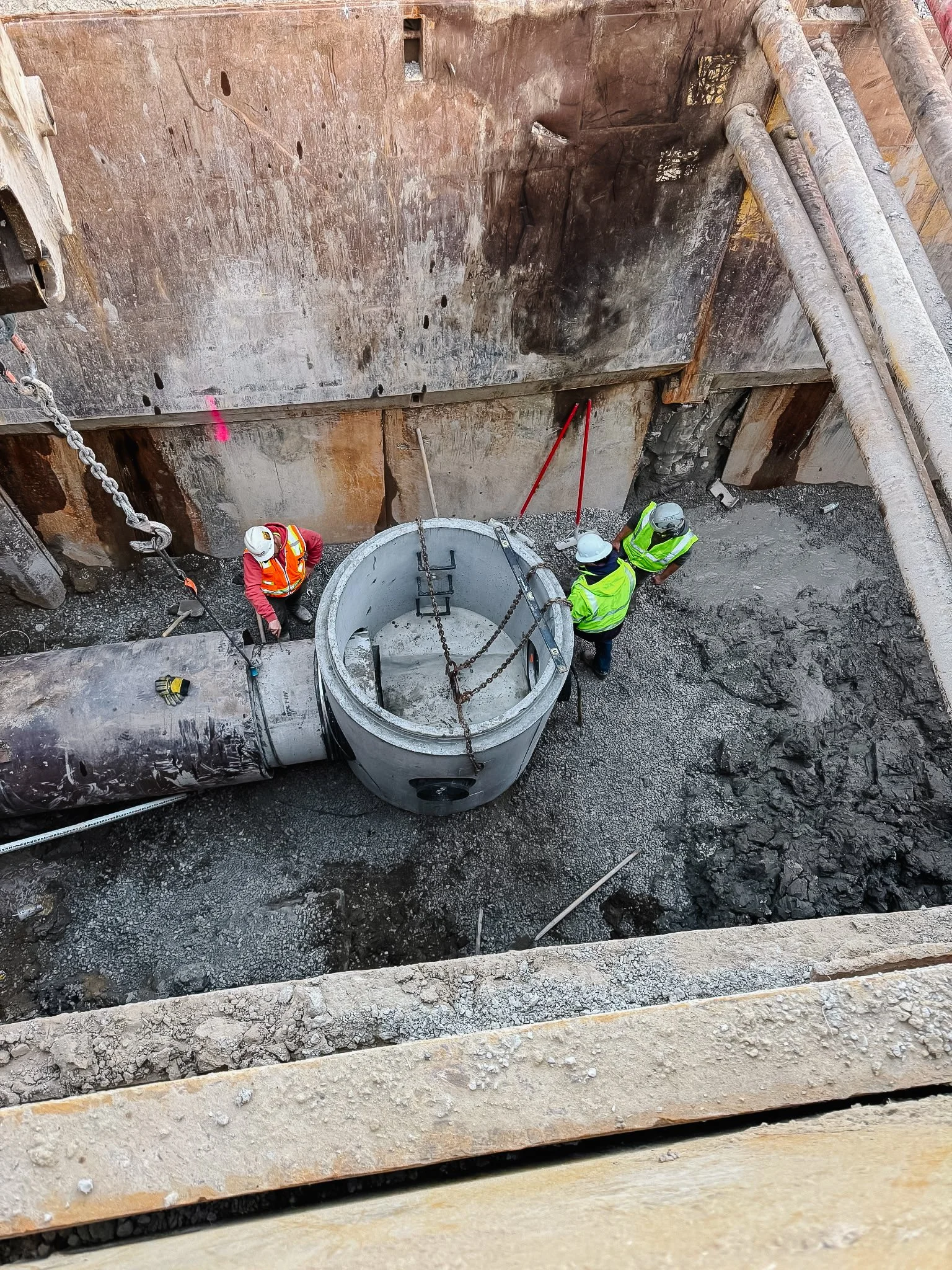 Dunigan Bros. crew members installing underground utility pipe in an open cut trench