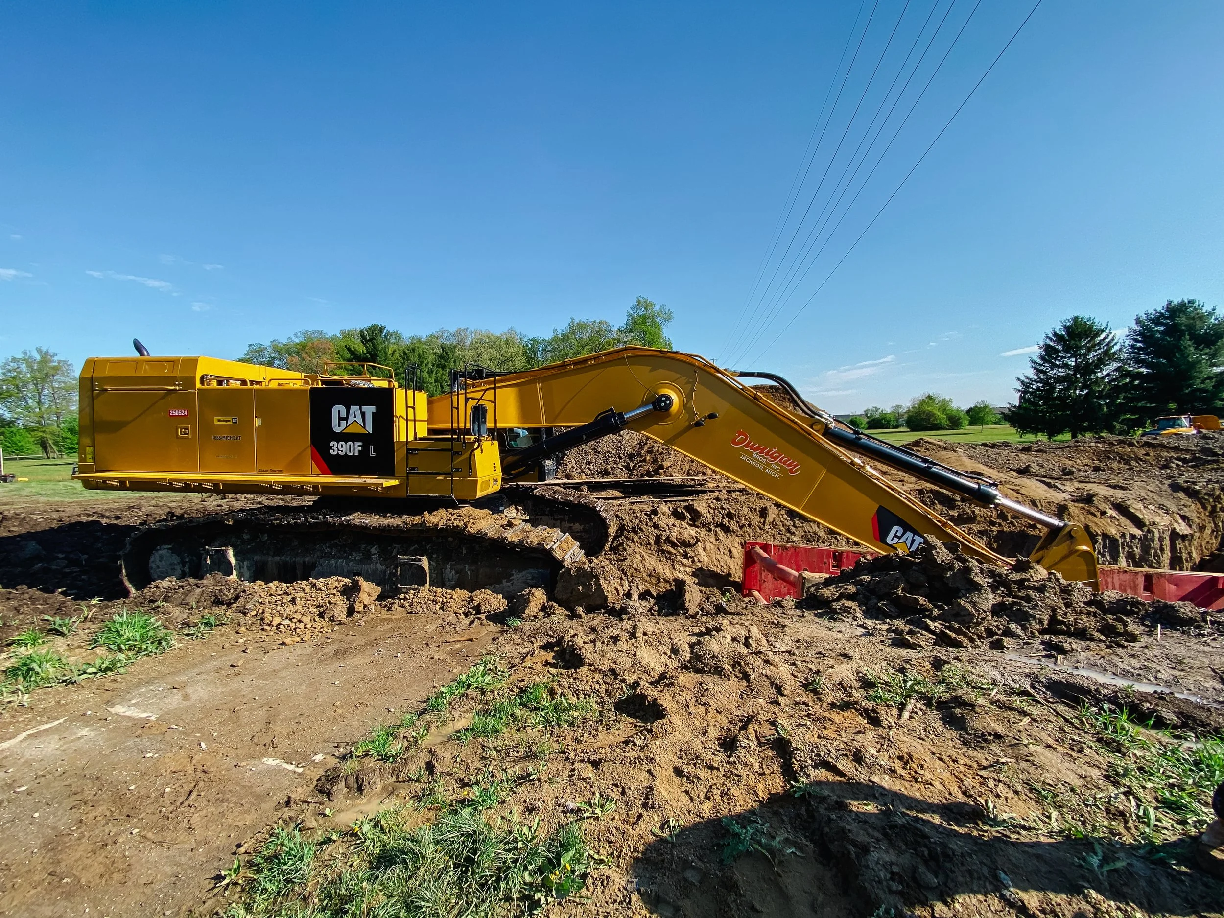 Dunigan Bros. excavator performing mass excavation on an active construction site