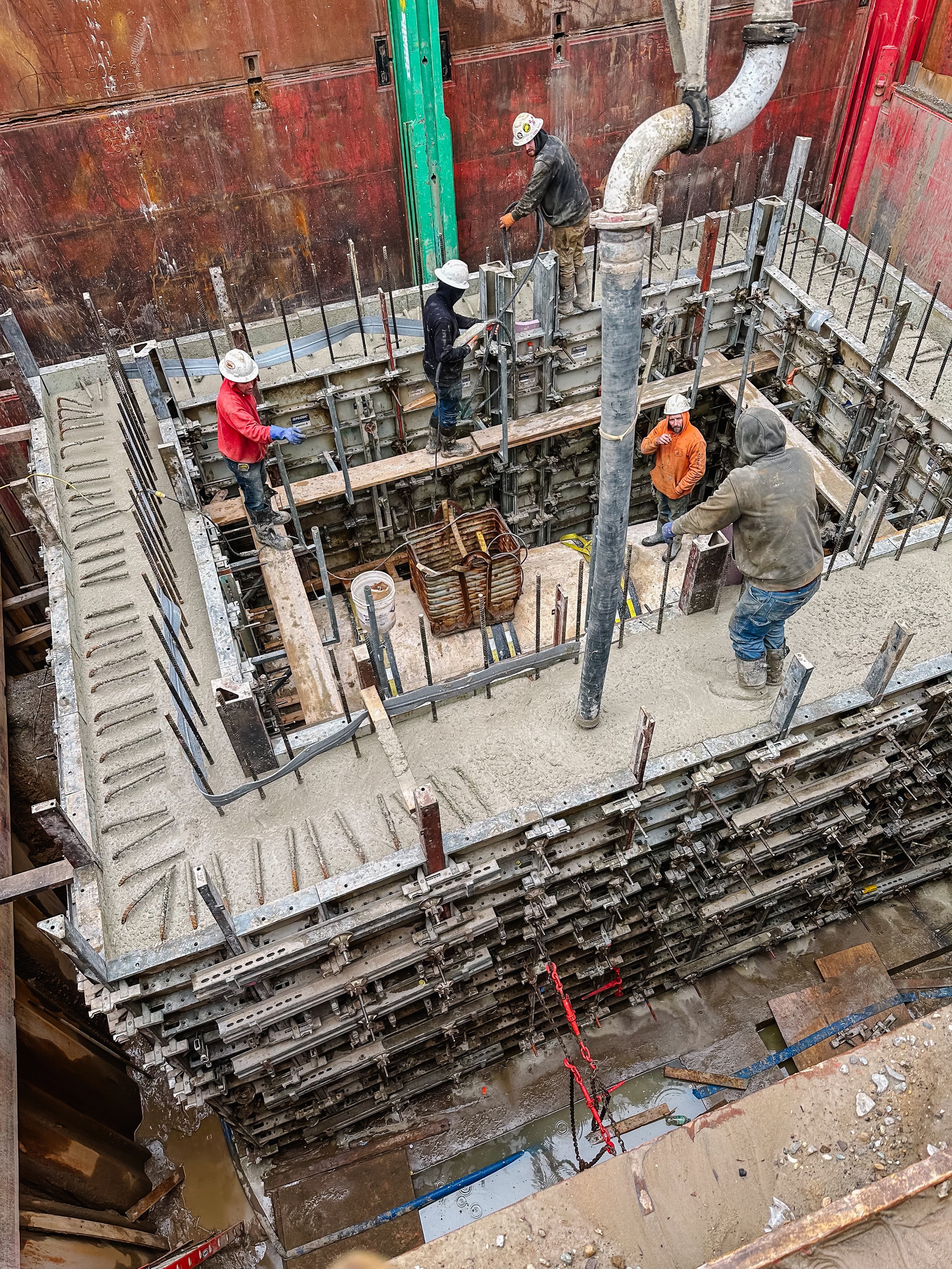 Dunigan Bros. crew members performing structural concrete work in a deep excavation