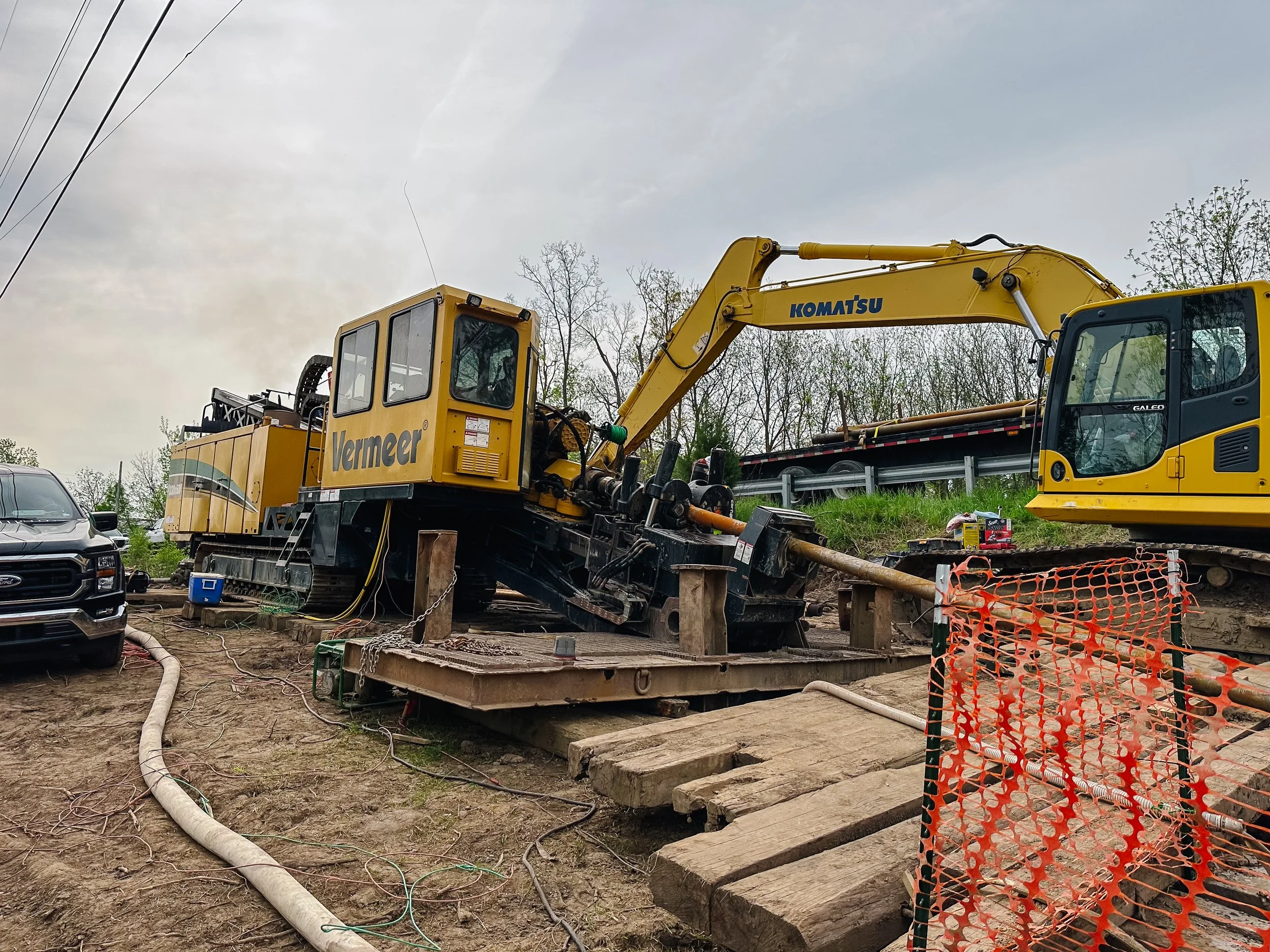 Dunigan Bros. Komatsu excavator and Vermeer boring machine on an active trenchless construction site