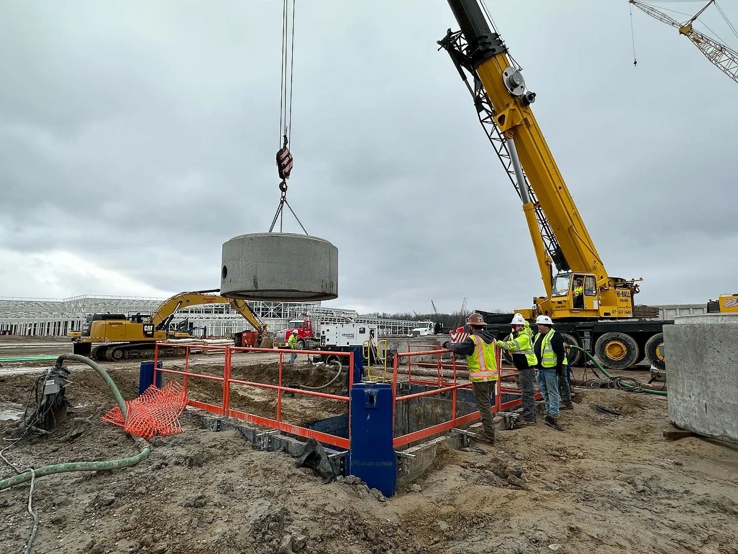 Dunigan Bros. crane positioning large diameter concrete casing on a tunneling and boring project