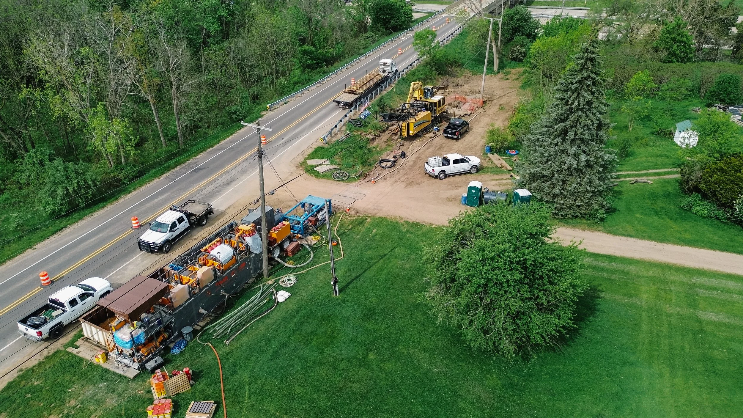 Aerial view of Dunigan Bros. active construction site with equipment and crew along a roadside corridor
